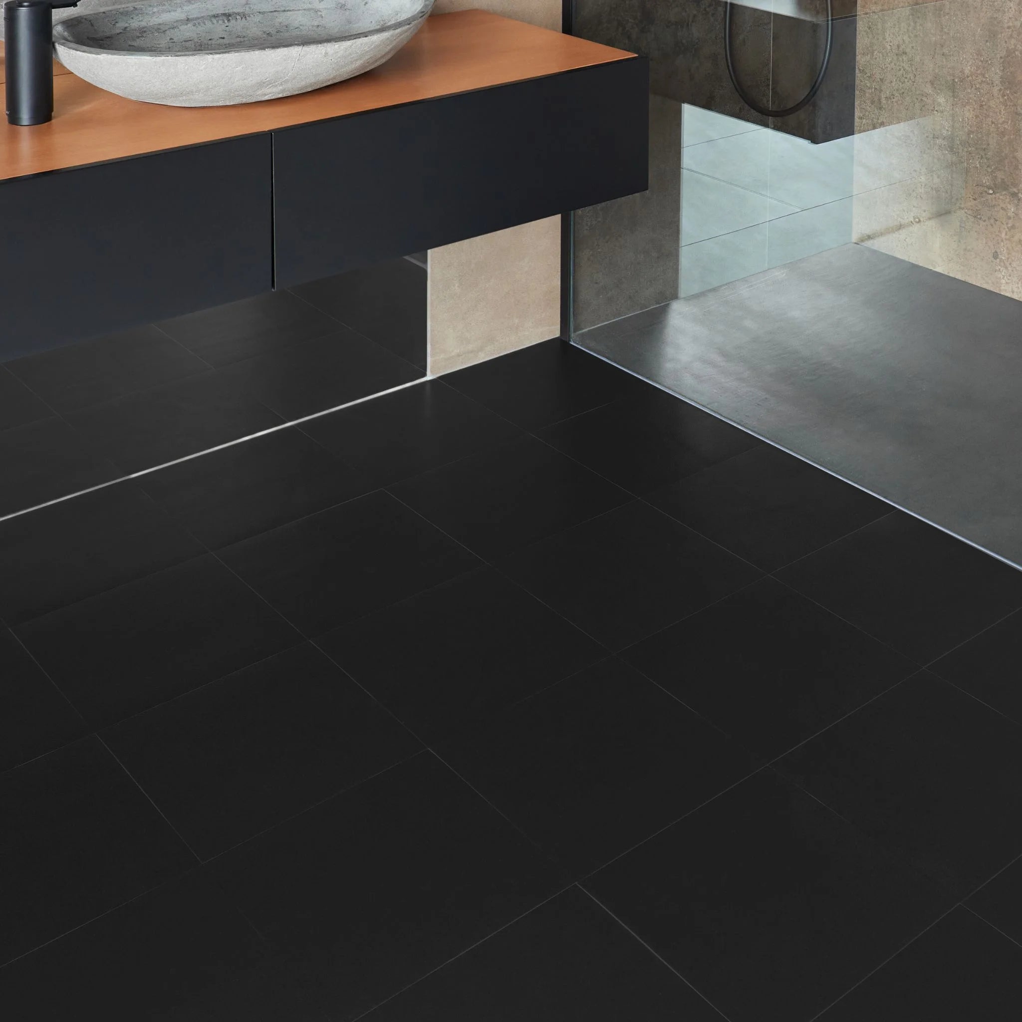 Black vinyl tile flooring in a modern bathroom setting