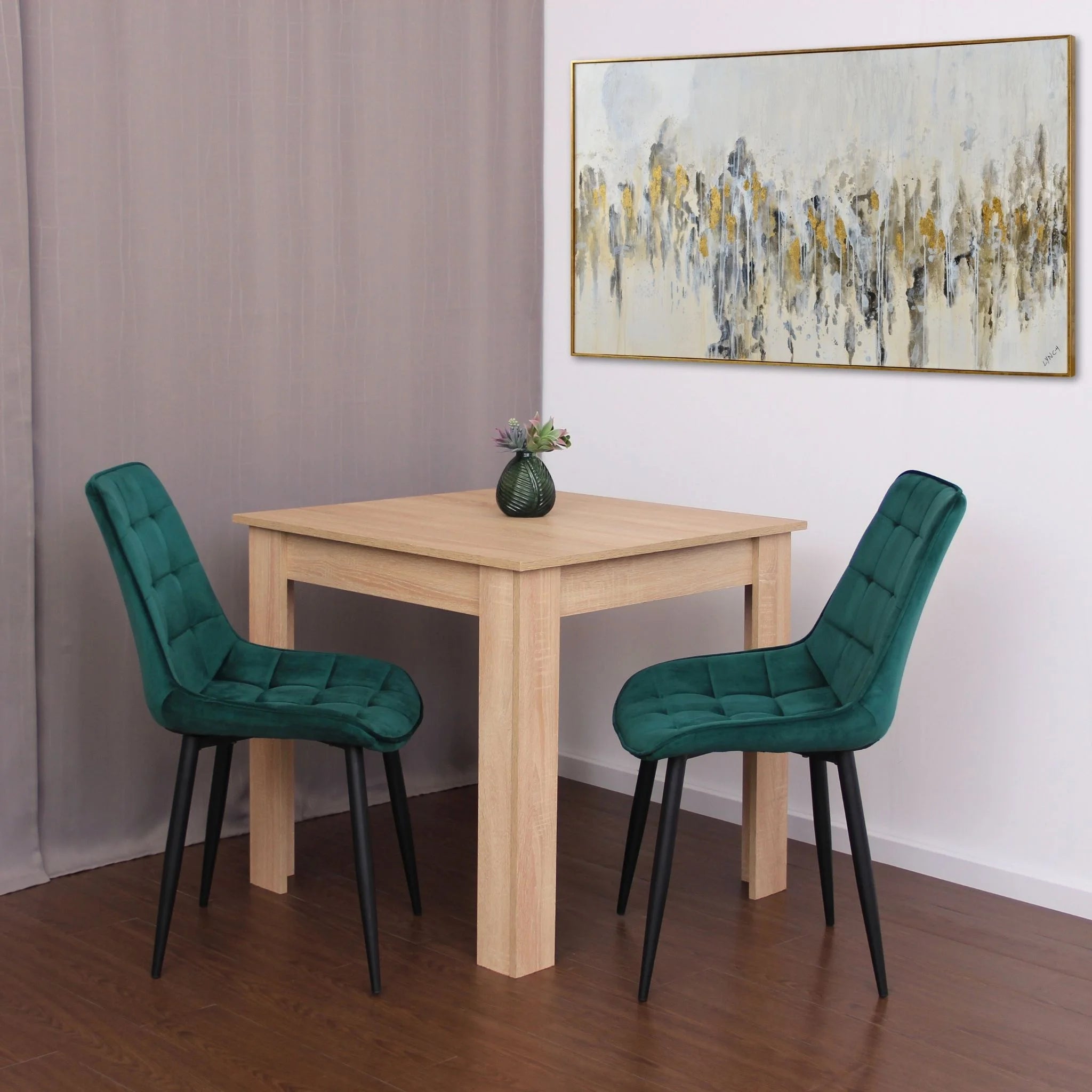 minimalist dining setup featuring green velvet chairs on brown wood effect flooring