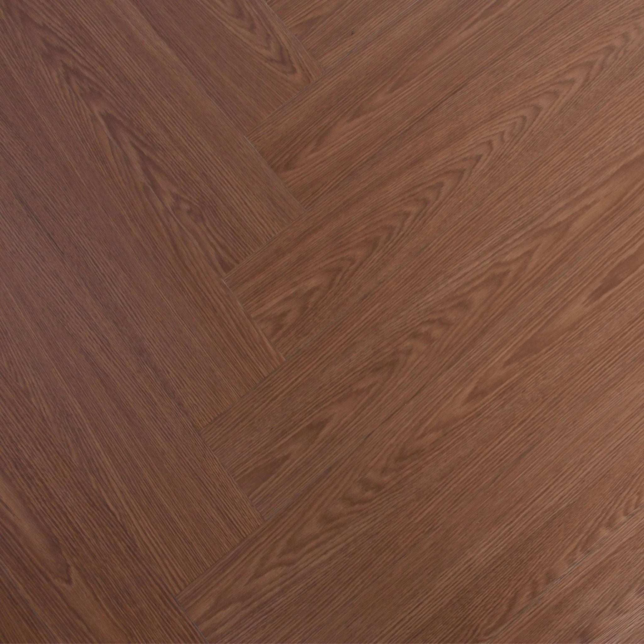 herringbone patterned wood effect vinyl flooring in a rich brown tone