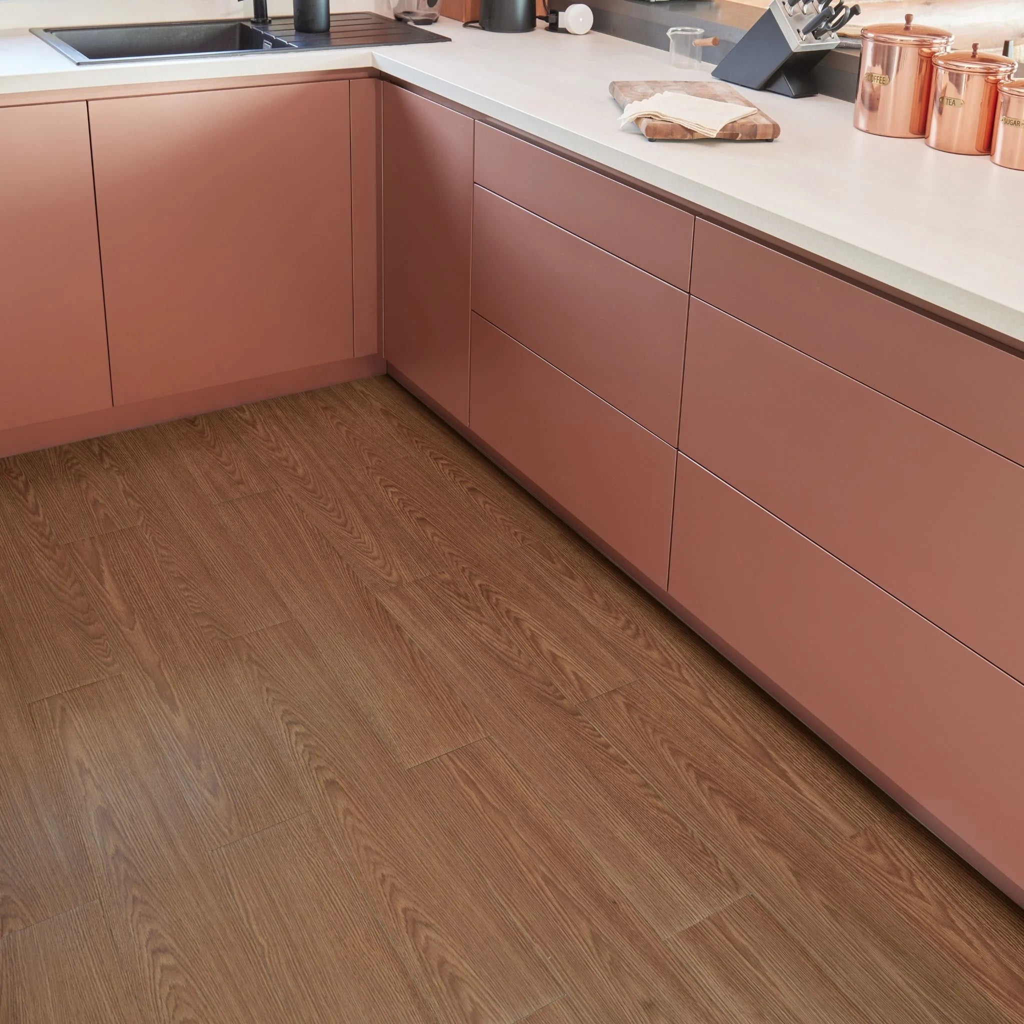 modern kitchen corner with brown cabinets and brown wood-effect flooring