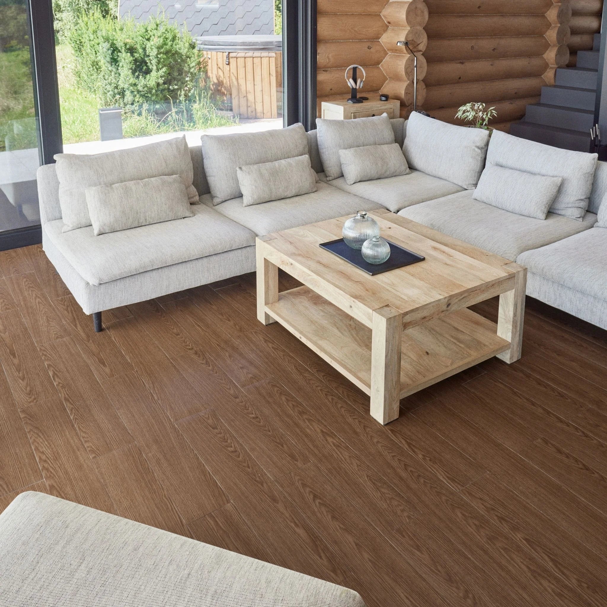 contemporary living room with large beige sofa, wooden coffee table, and light wood flooring