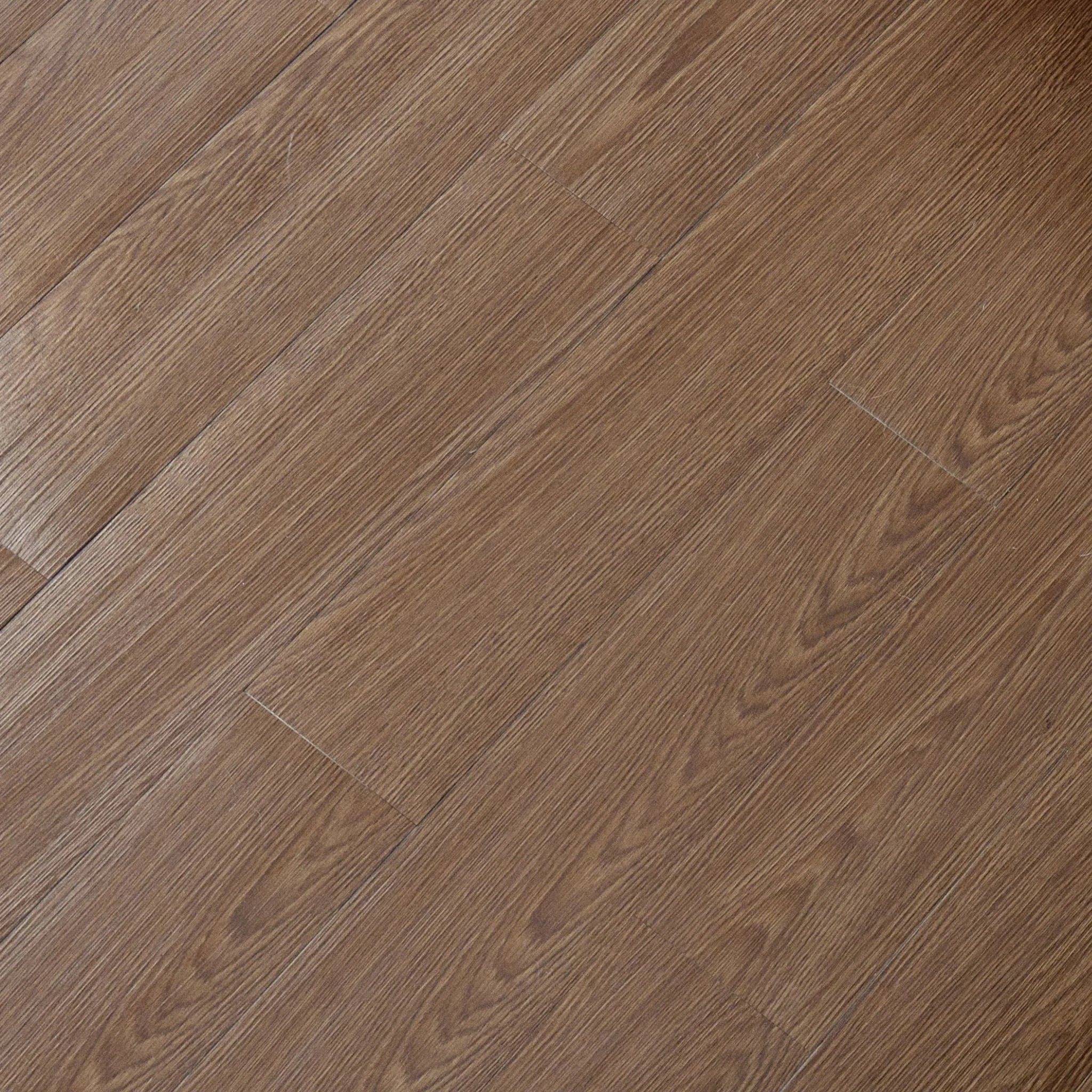 close-up of a wood-effect vinyl plank in brown undertones