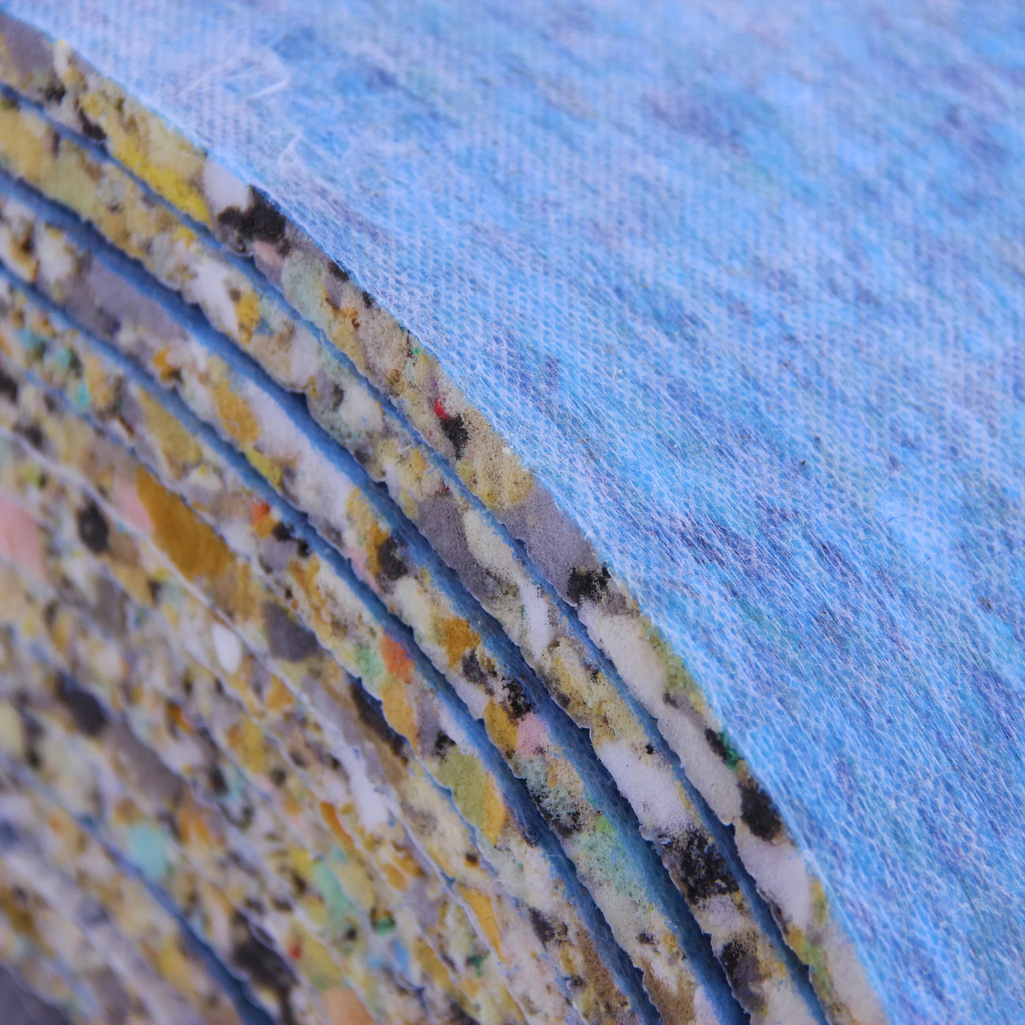 Close-up of recycled foam carpet underlay layers