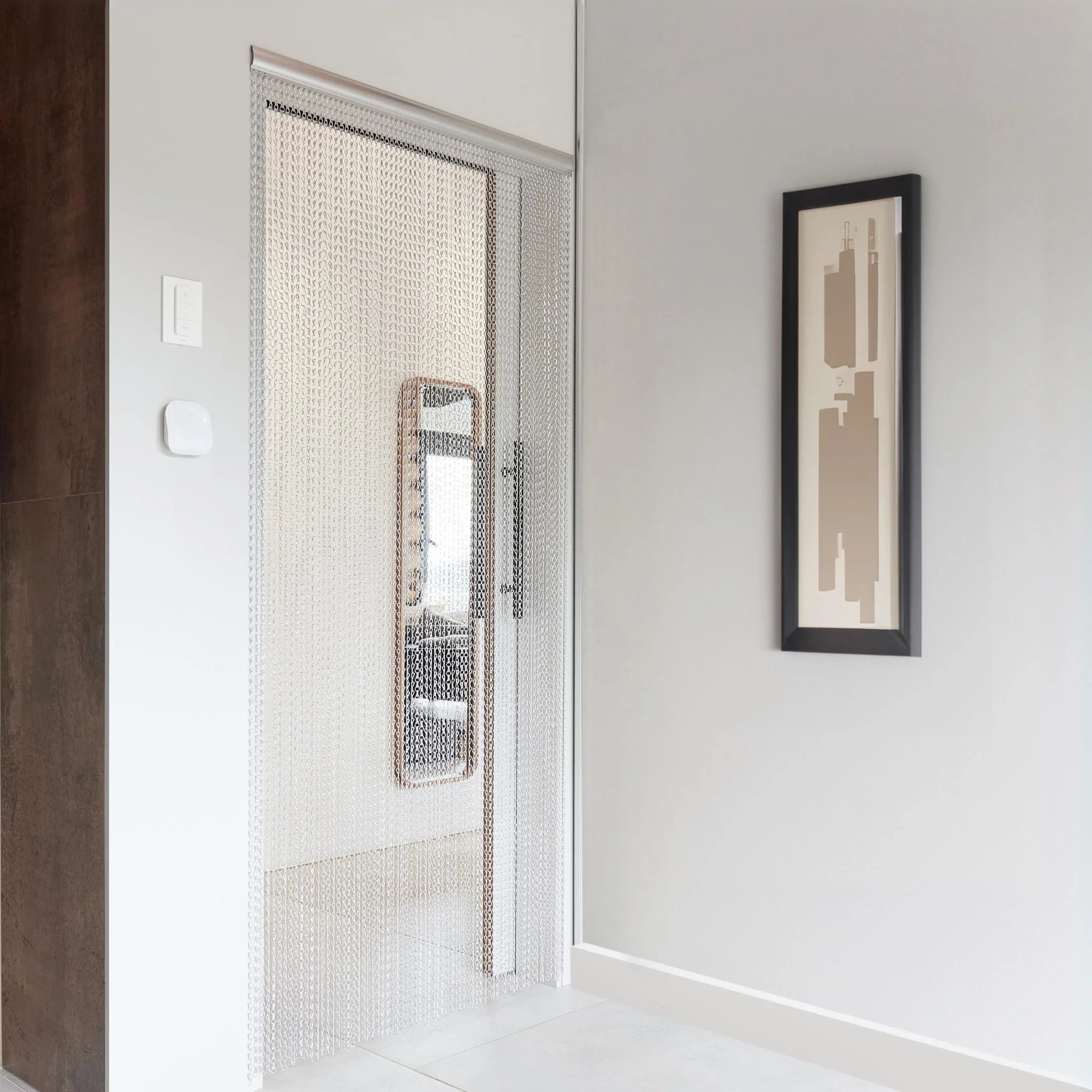 Metal fly curtain hanging in a living room doorway
