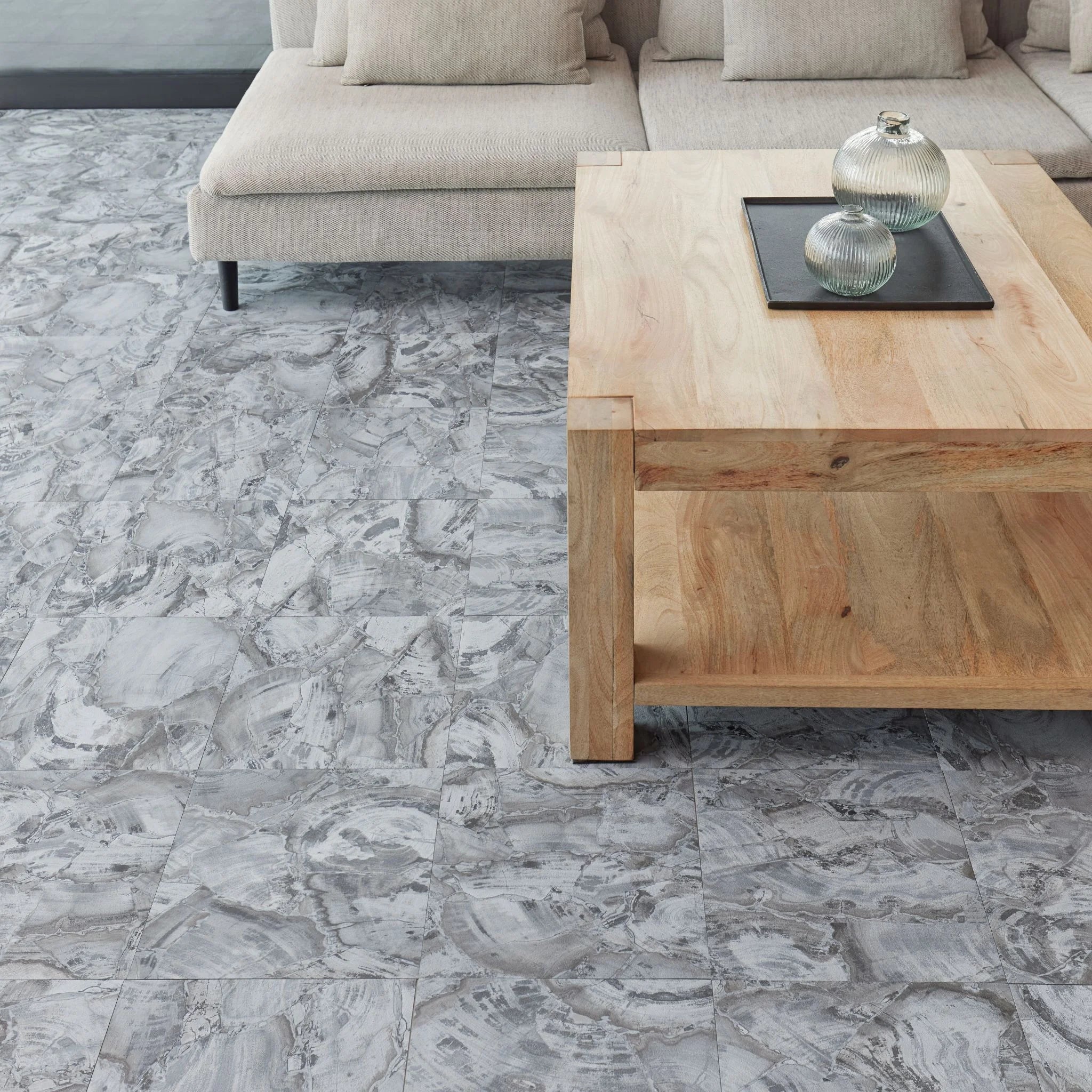 modern living room featuring grey sofa and light wood furniture on marble charcolar flooring