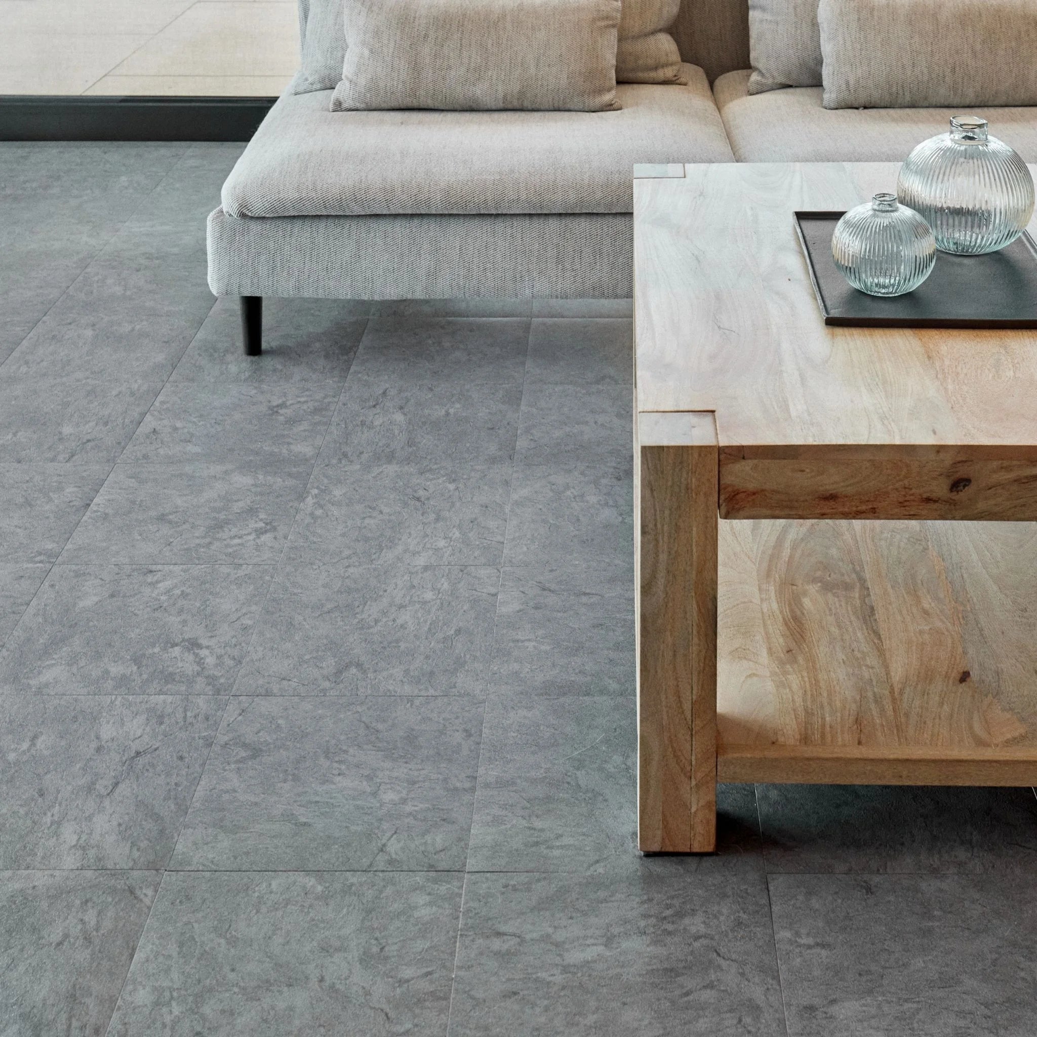 spacious living room with rustic furniture and grey tile-effect concrete flooring