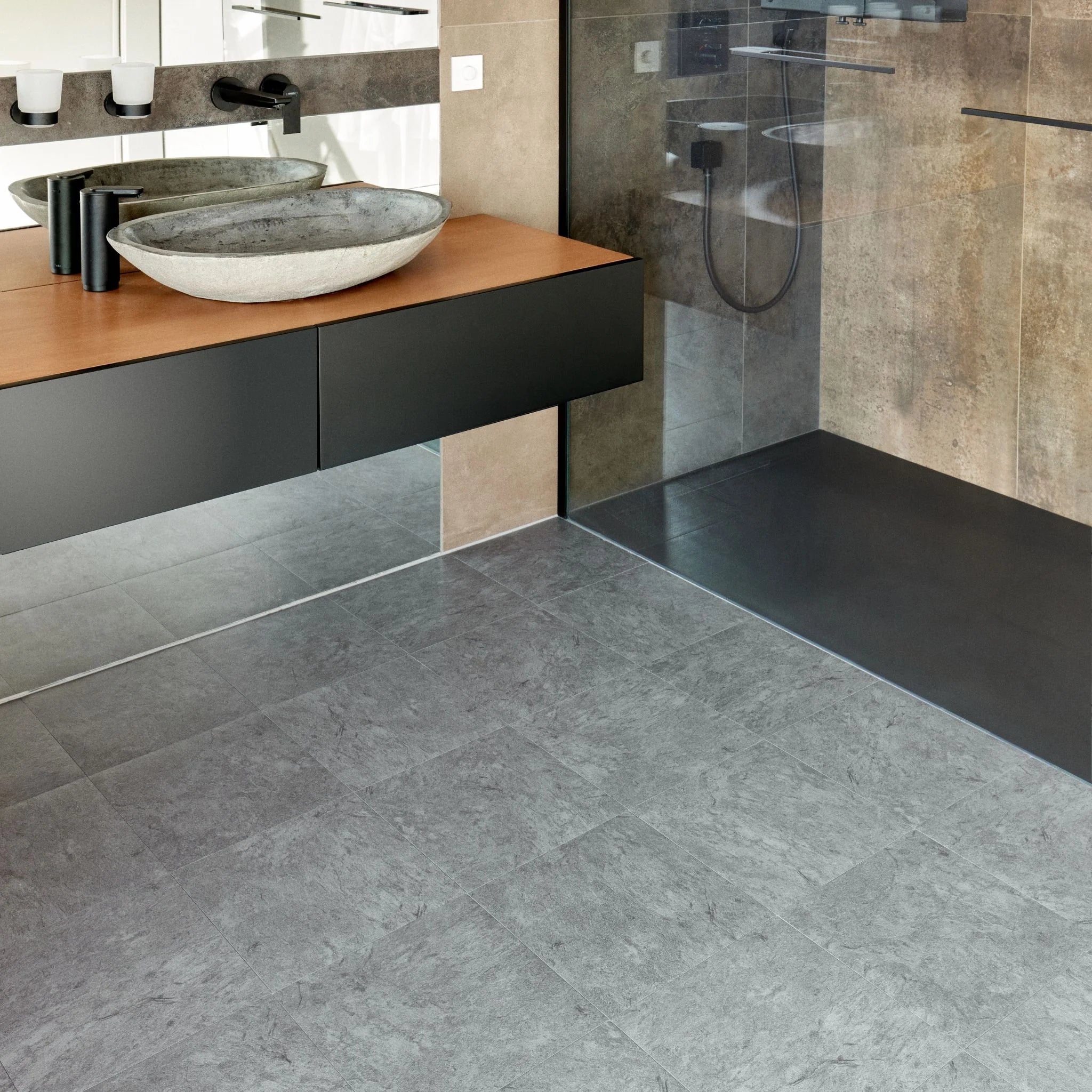 modern bathroom with black vanity, textured grey floor, and minimal accessories