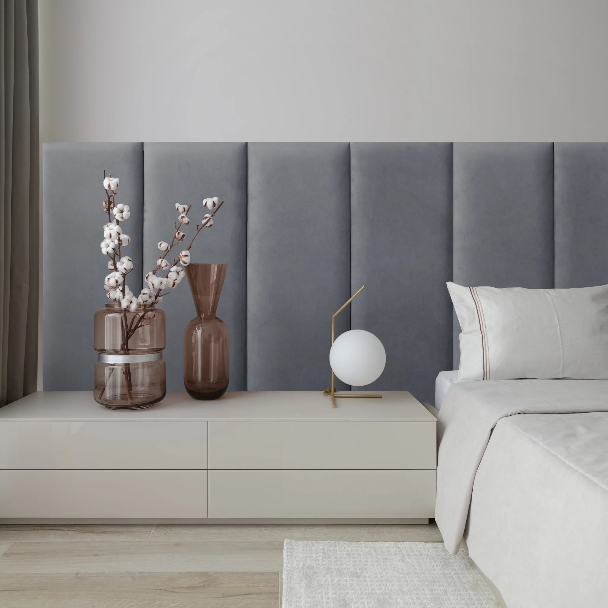 Modern bedroom with graphite upholstered wall panel featuring padded surface 