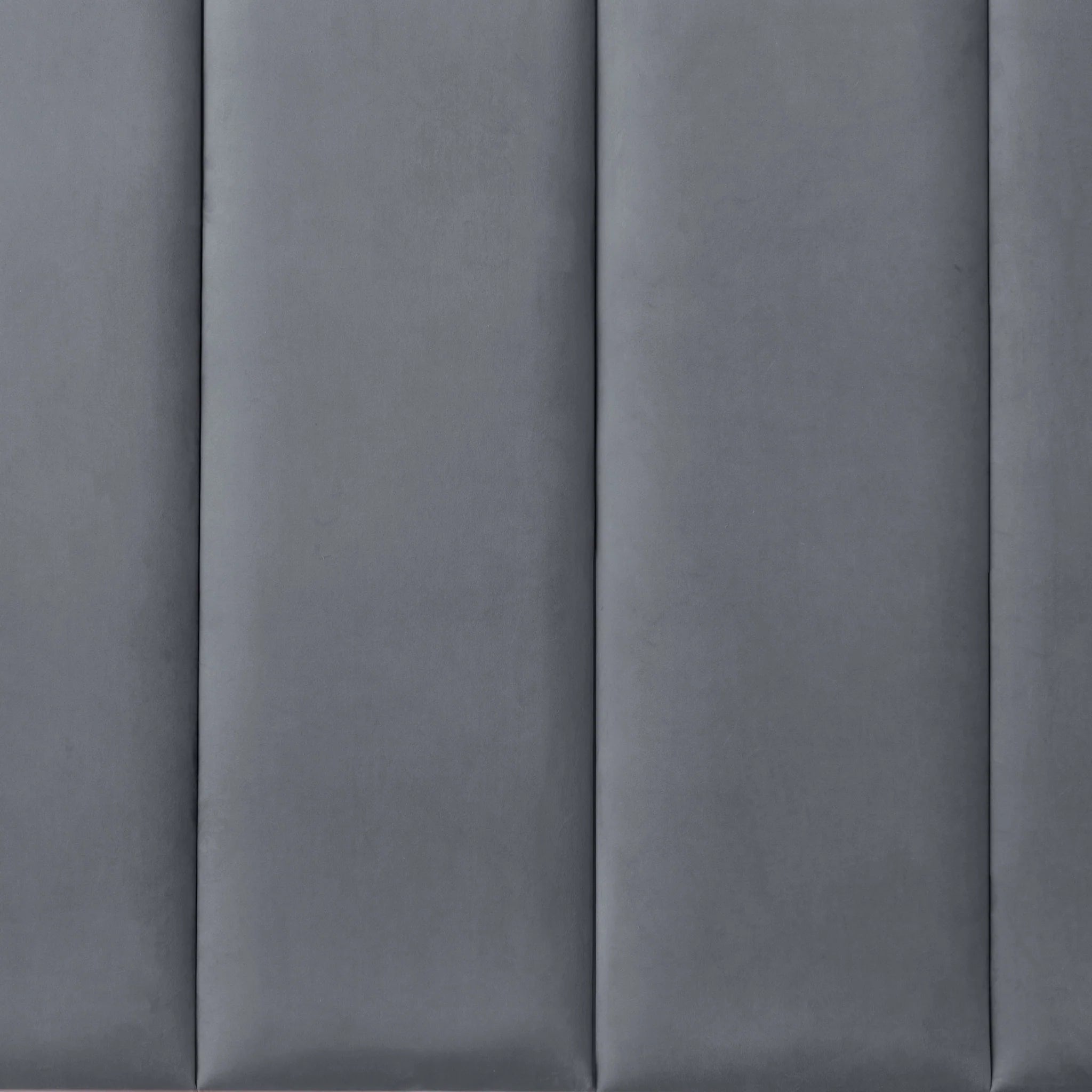 Graphite upholstered wall panel with padded surface, close-up view