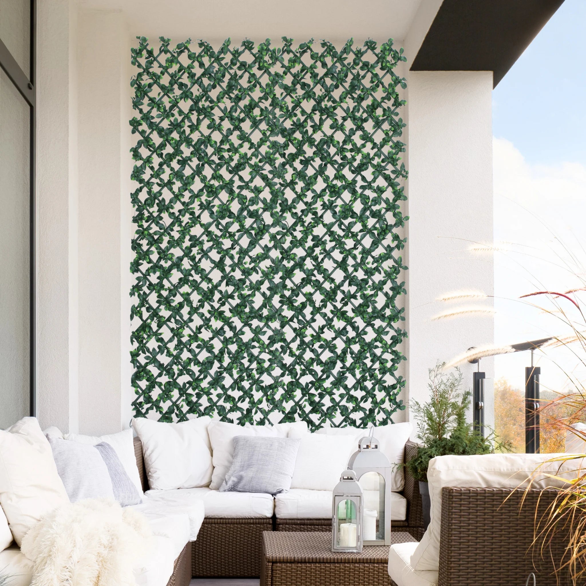 expanding trellis with artificial ficus leaves on balcony wall