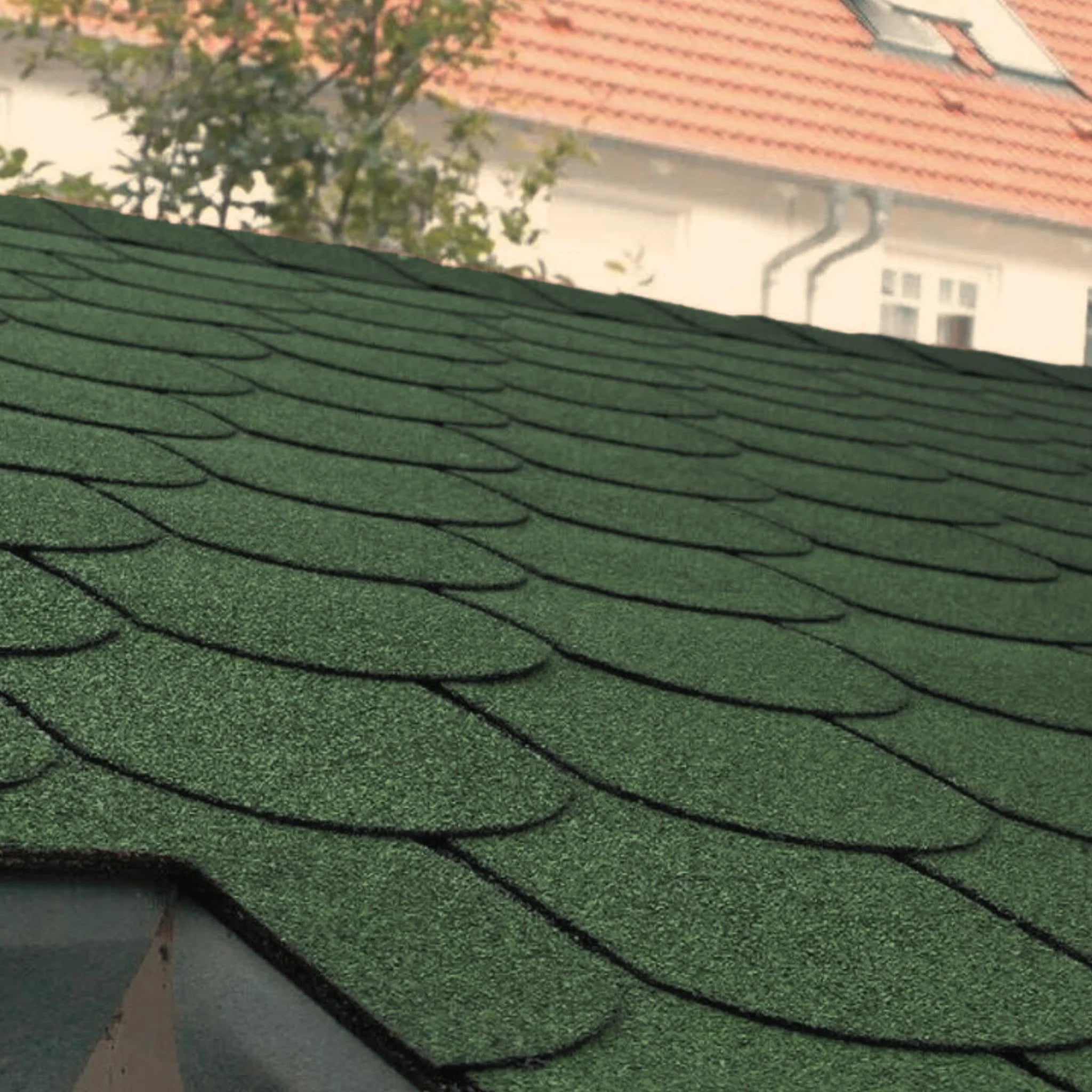 roof with installed green fish scales shape shingles against blue sky