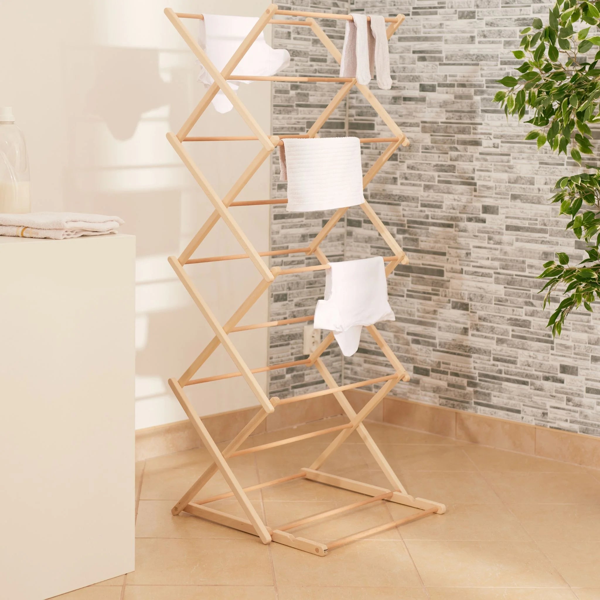 Foldable wooden clothes horse in laundry room