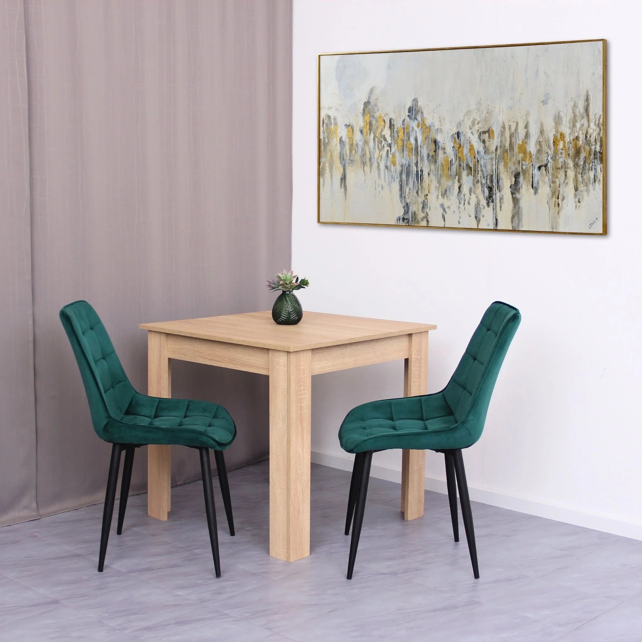 minimalist dining setup featuring green velvet chairs on grey tile effect flooring