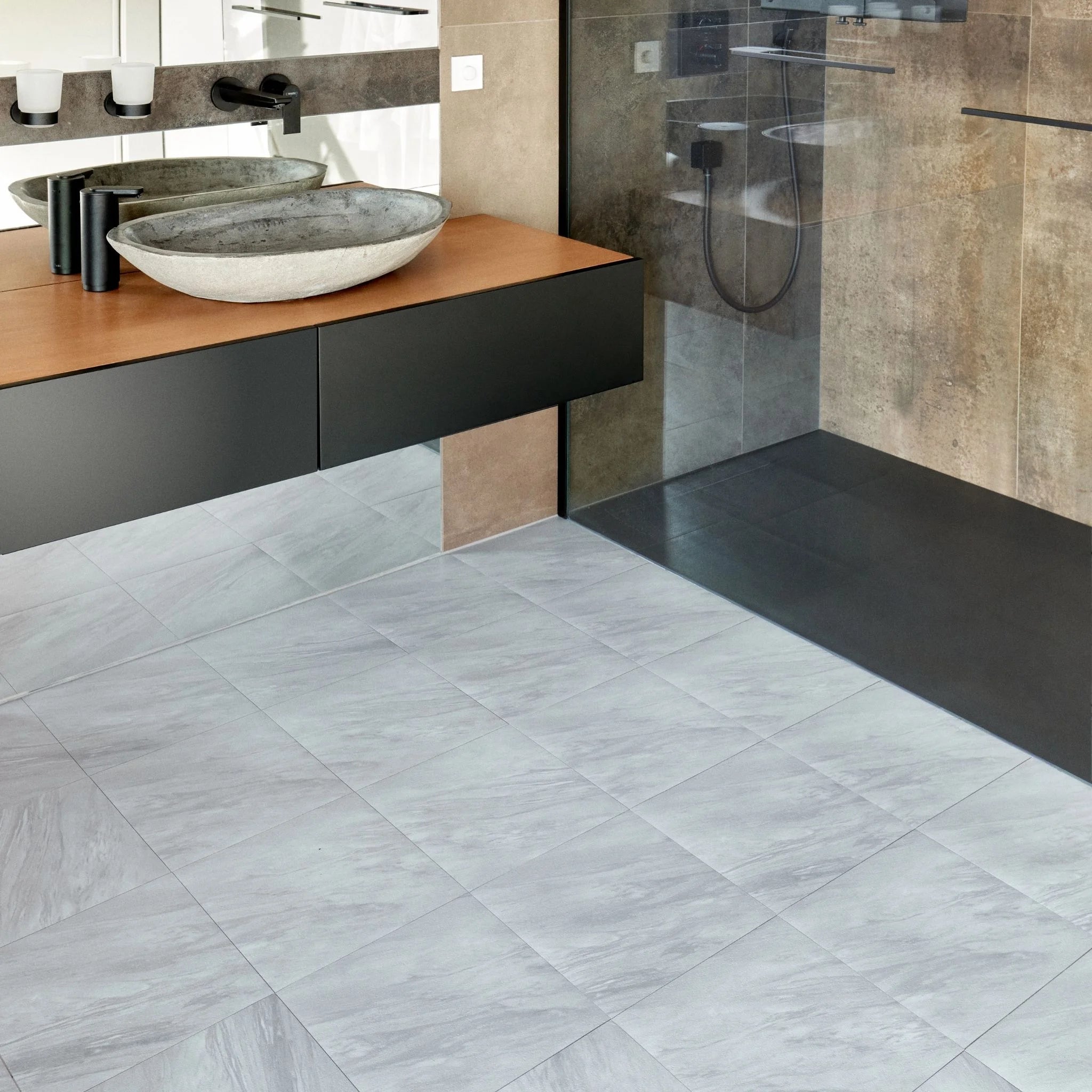 modern bathroom with black vanity, textured grey floor, and minimal accessories