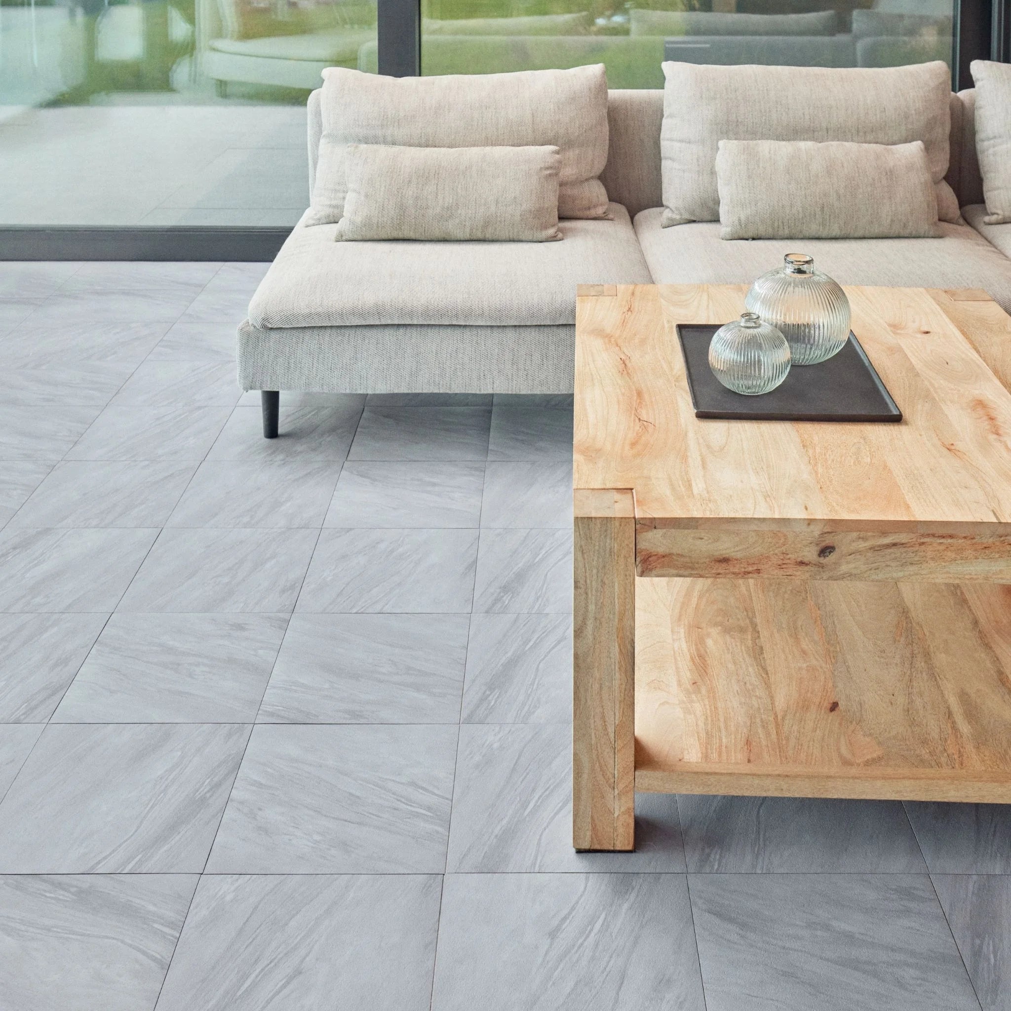 spacious living room with rustic furniture and grey tile-effect concrete flooring