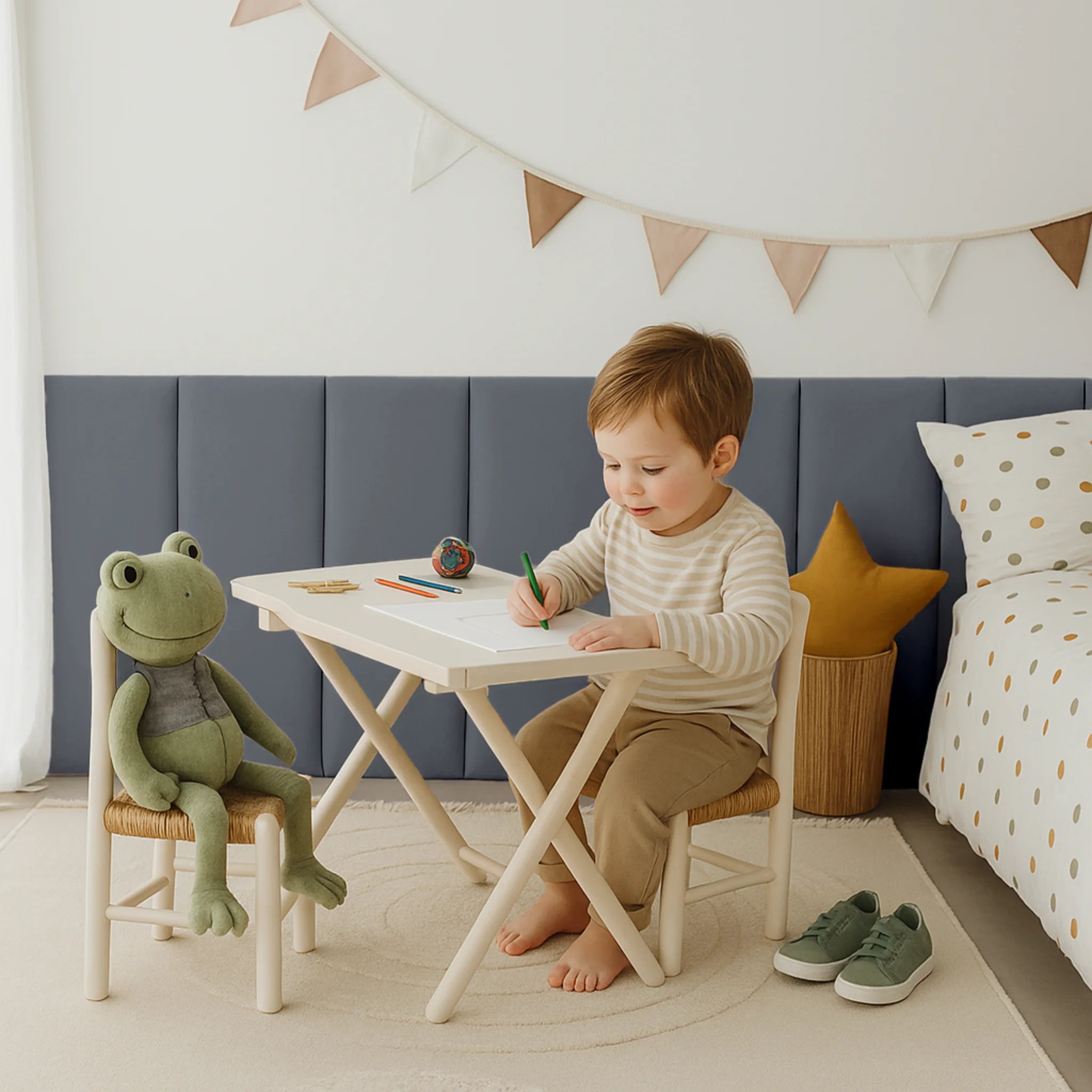 Child sitting at a table, with anti-collision padded wall panels in the background