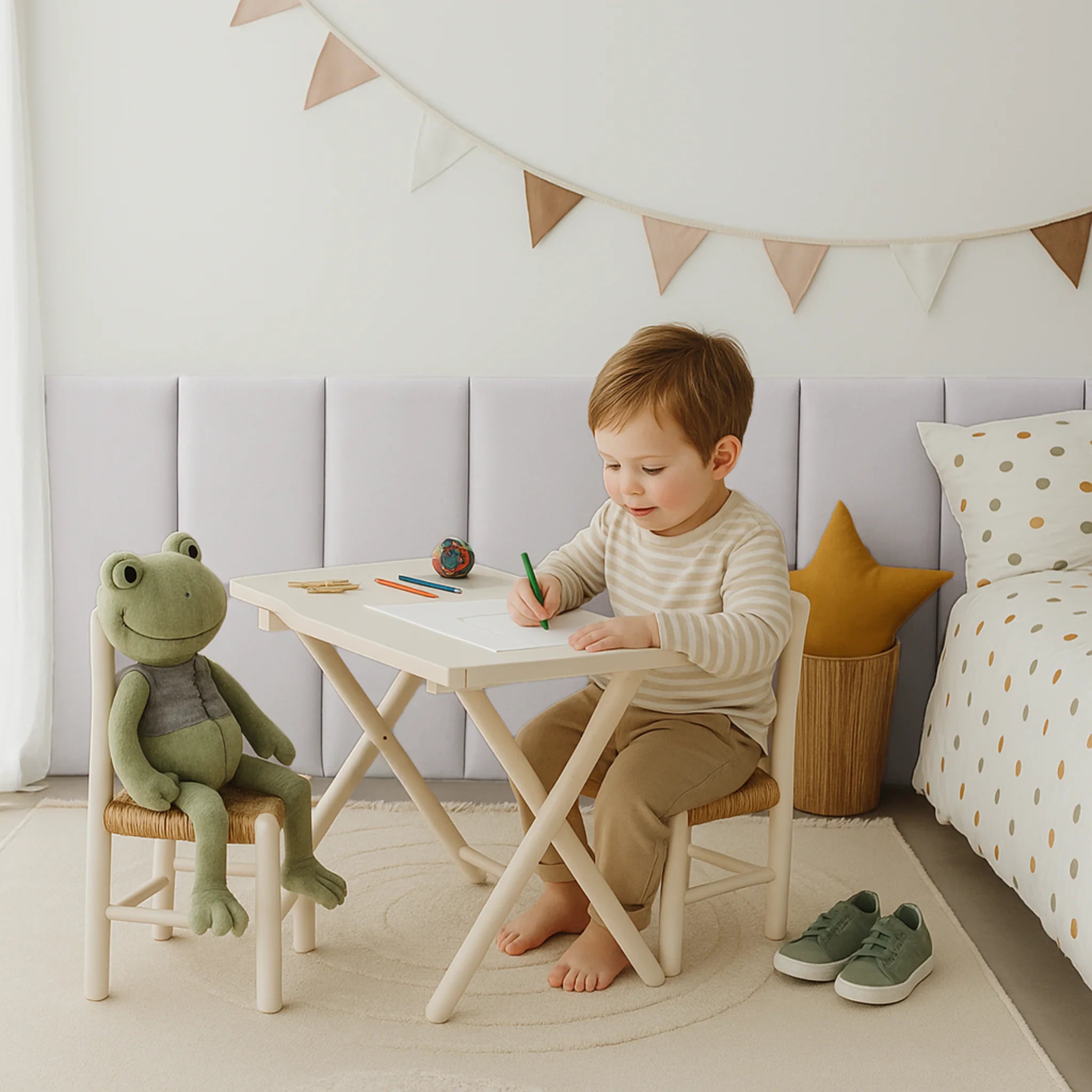 Child sitting at a table, with anti-collision padded wall panels in the background