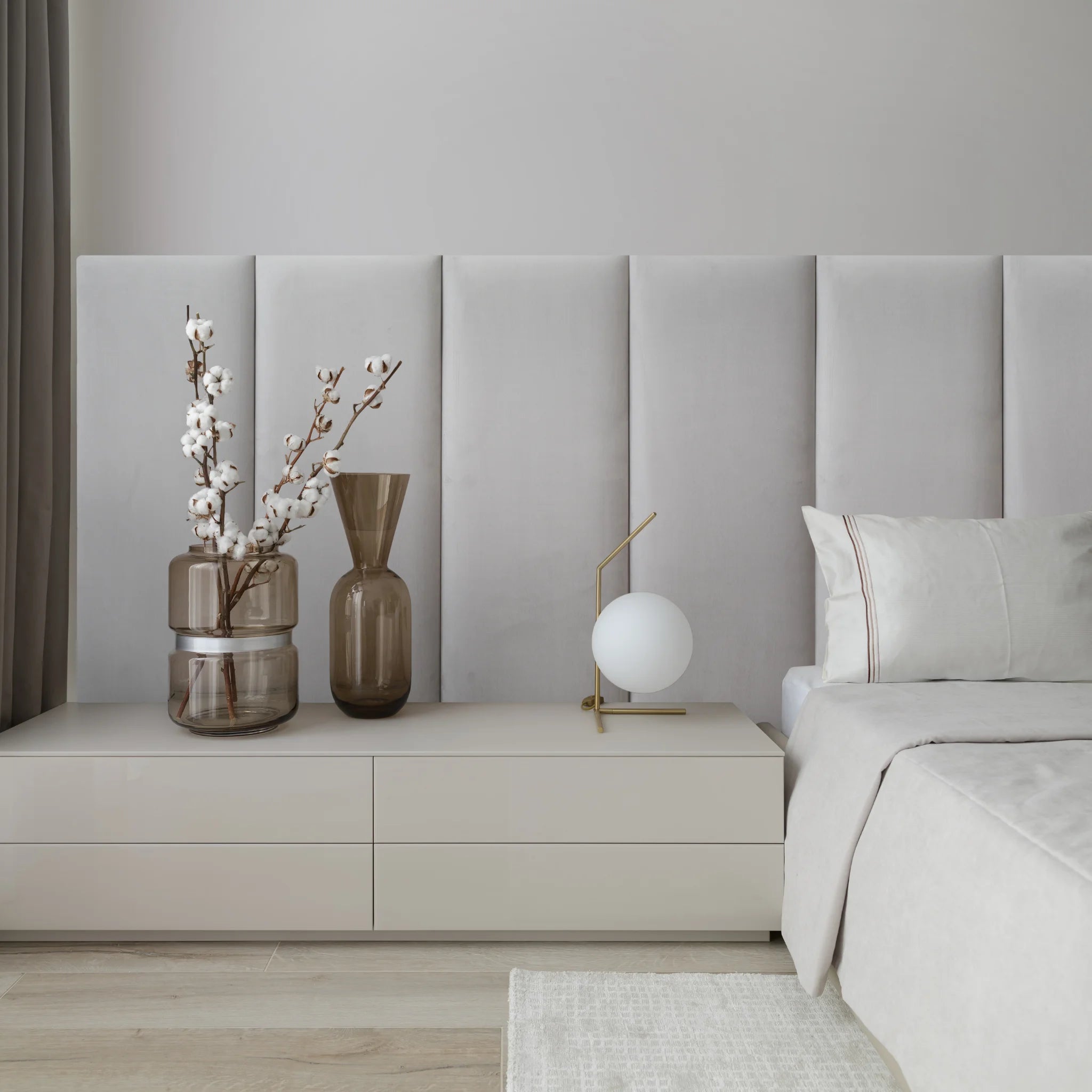 A cozy bedroom featuring grey headboards for beds