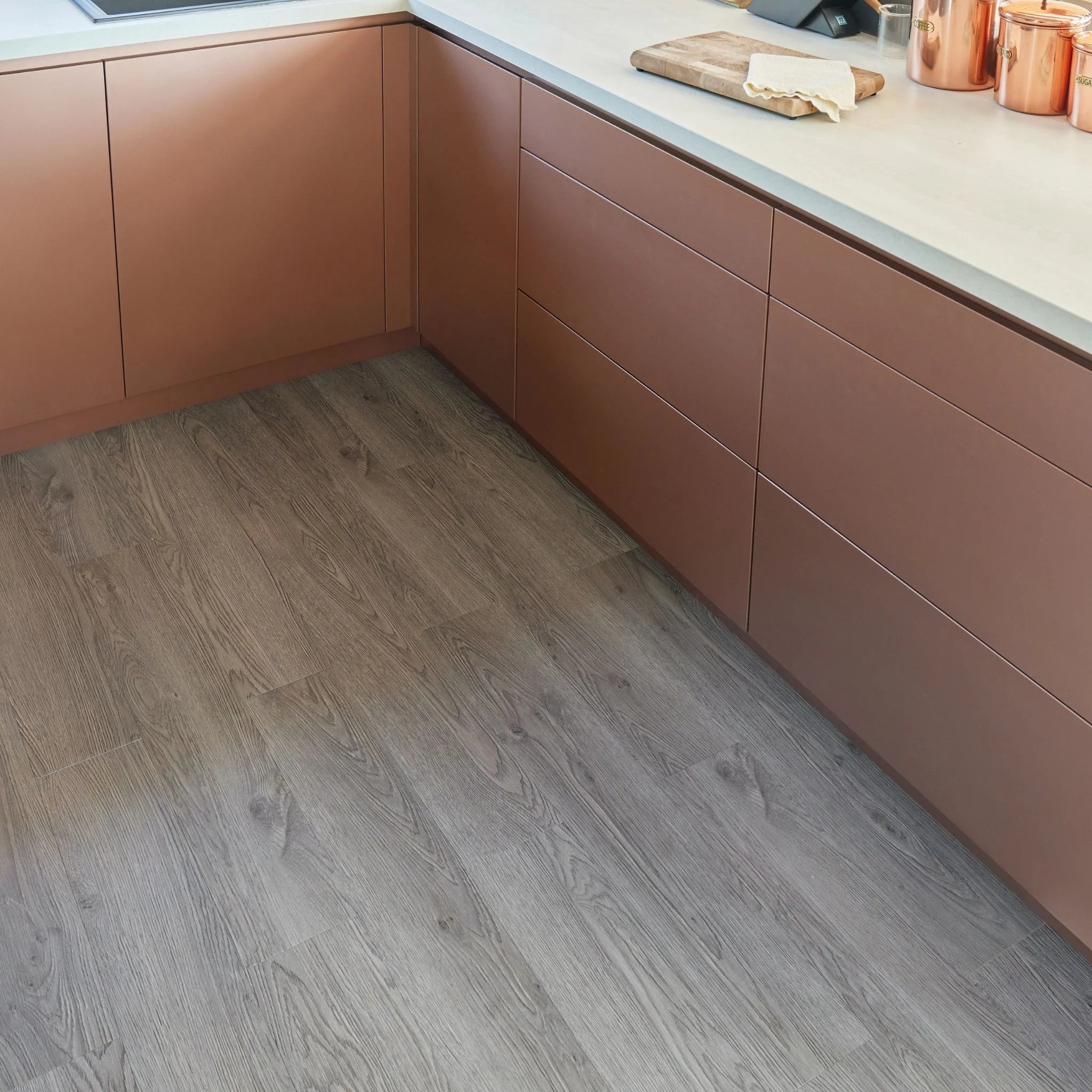modern kitchen corner with brown cabinets and dark brown wood-effect flooring