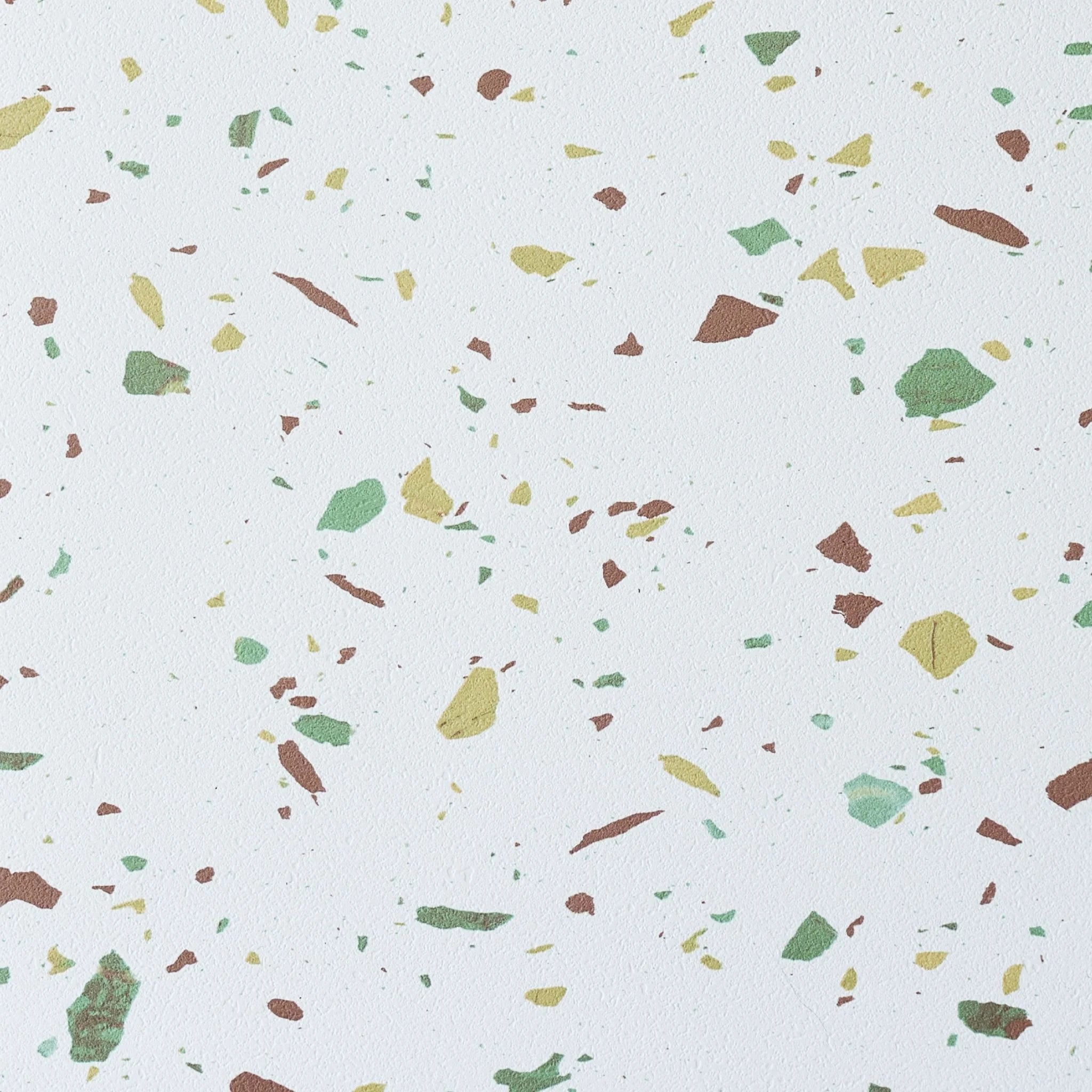 large square terrazzo tile close-up with green and brown specks