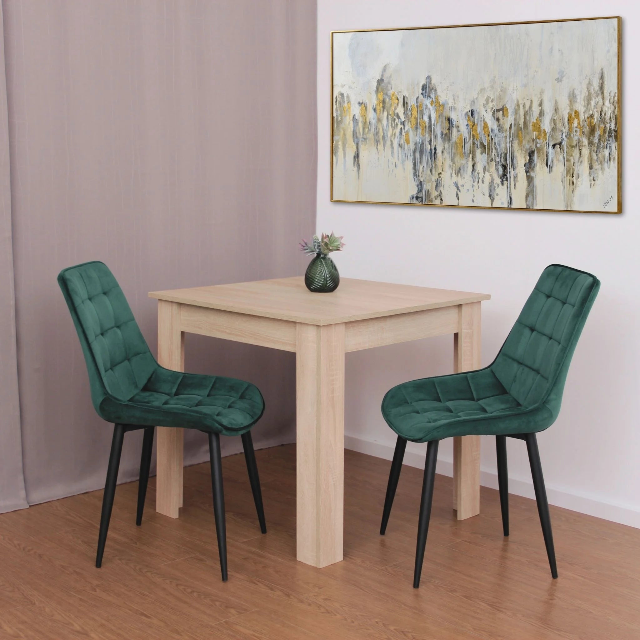 minimalist dining setup featuring green velvet chairs on brown wood effect flooring