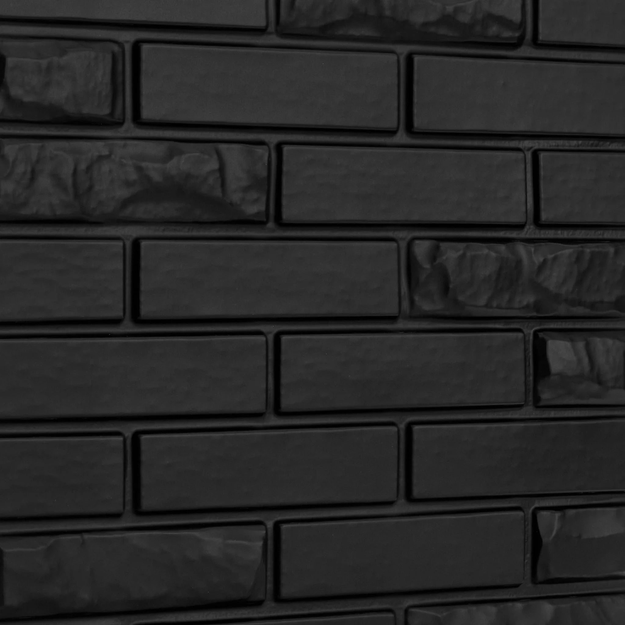 Close-up of black PVC wall panel with brick designs