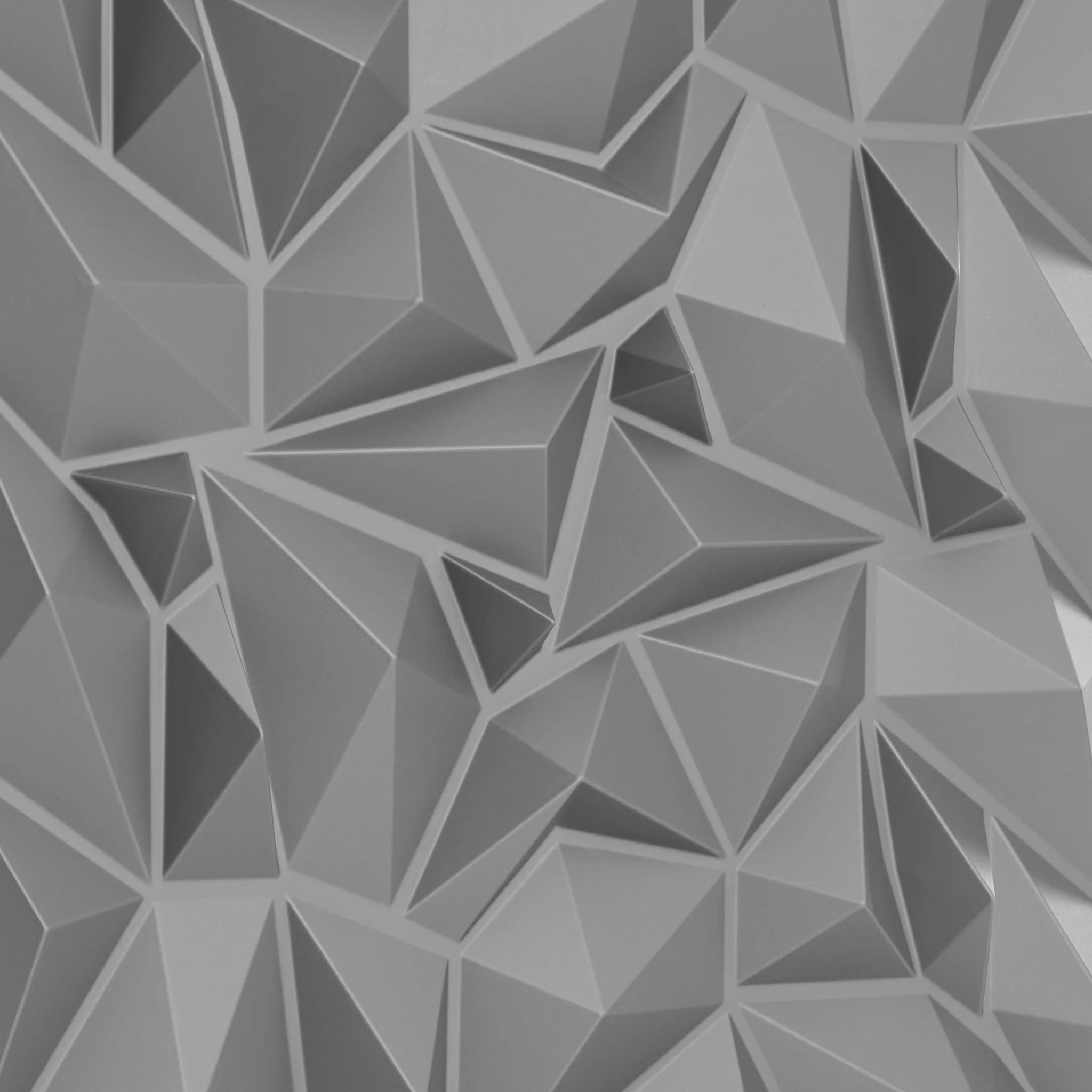 Close-up of silver PVC wall panel with geometric designs