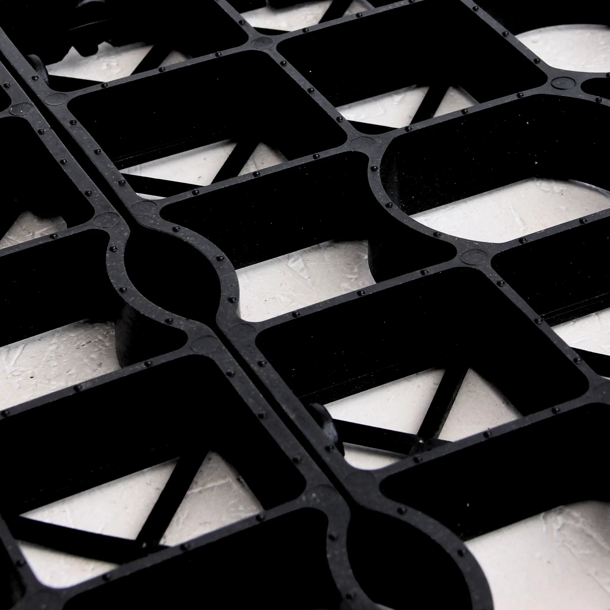 Close-up black plastic grid panel underside view