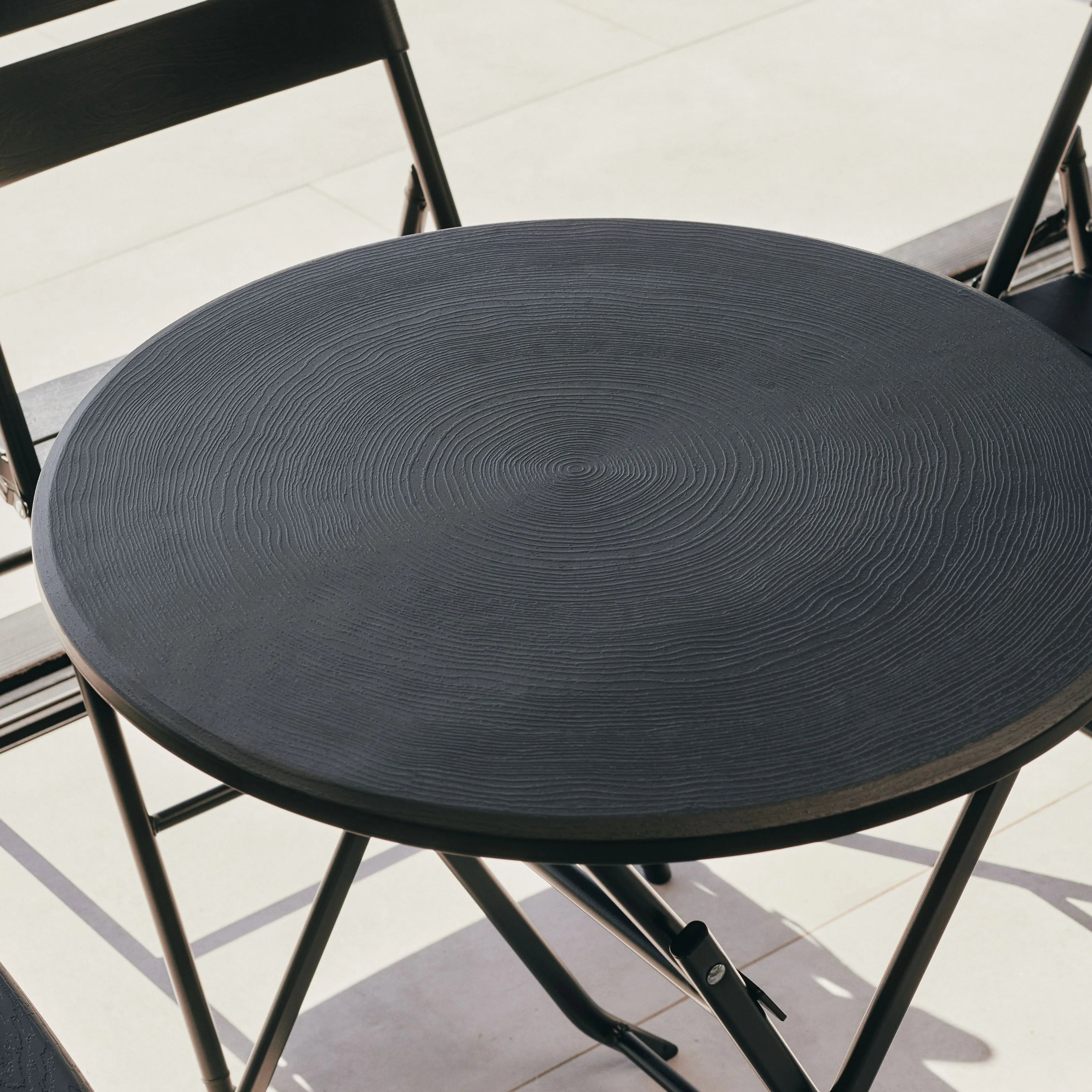 close up of black round table with chair