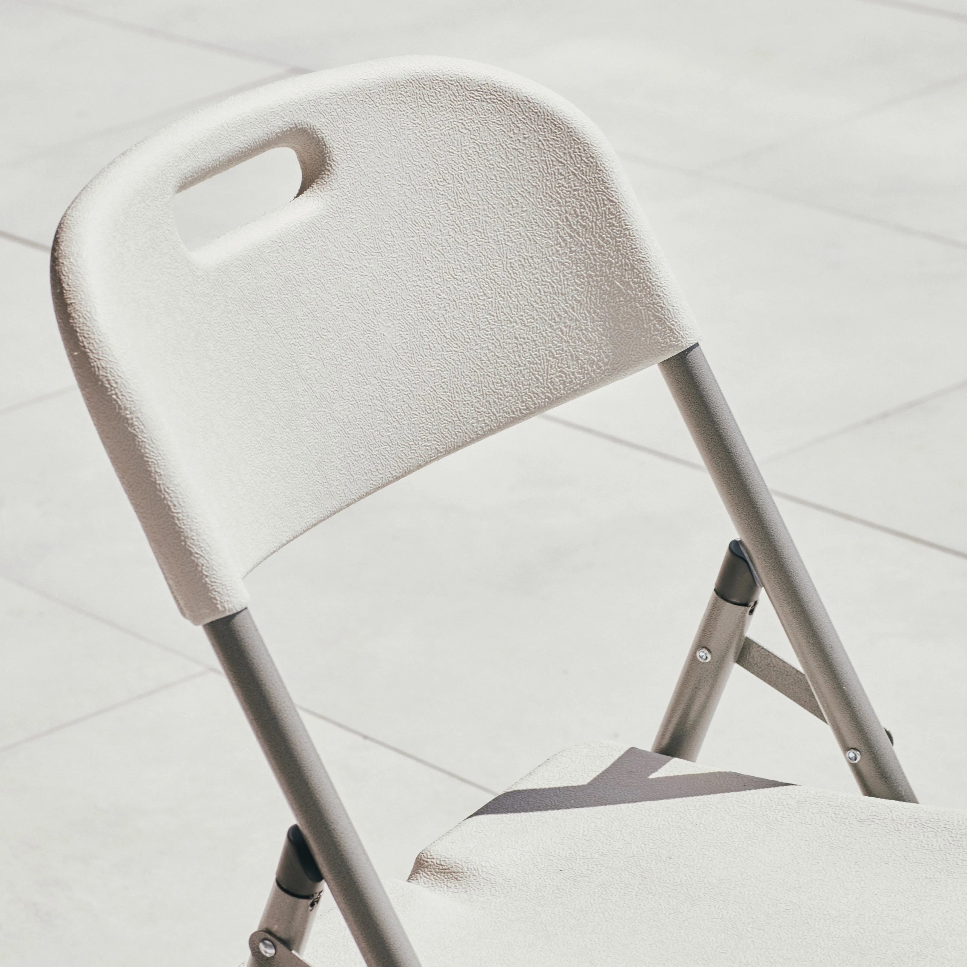 close up of white folding chair surface