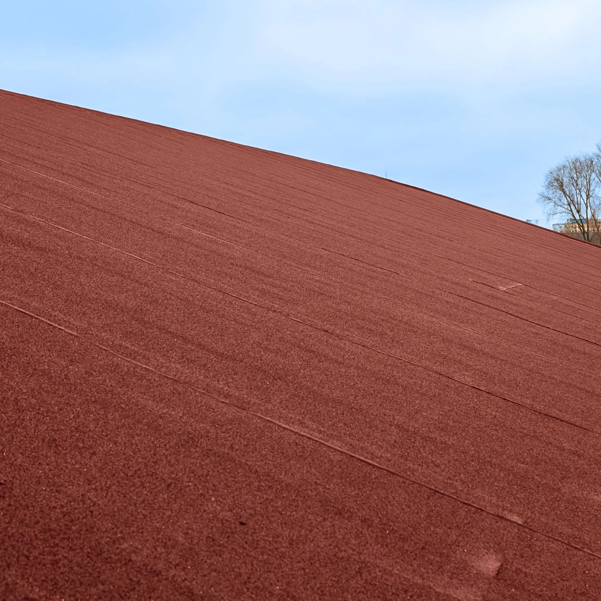 close-up of red roofing felt texture mineral finish