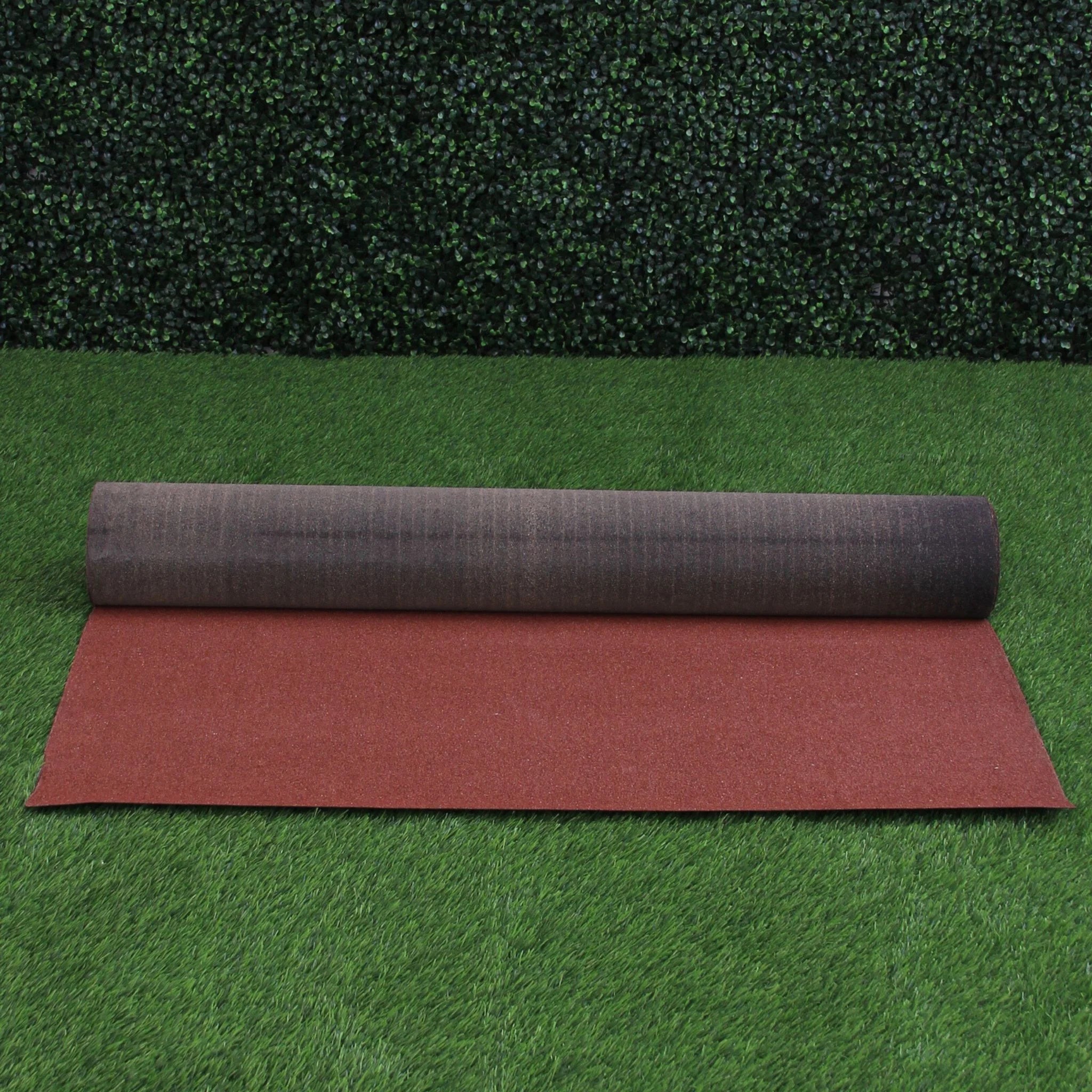 red roofing felt roll fully unrolled on grass