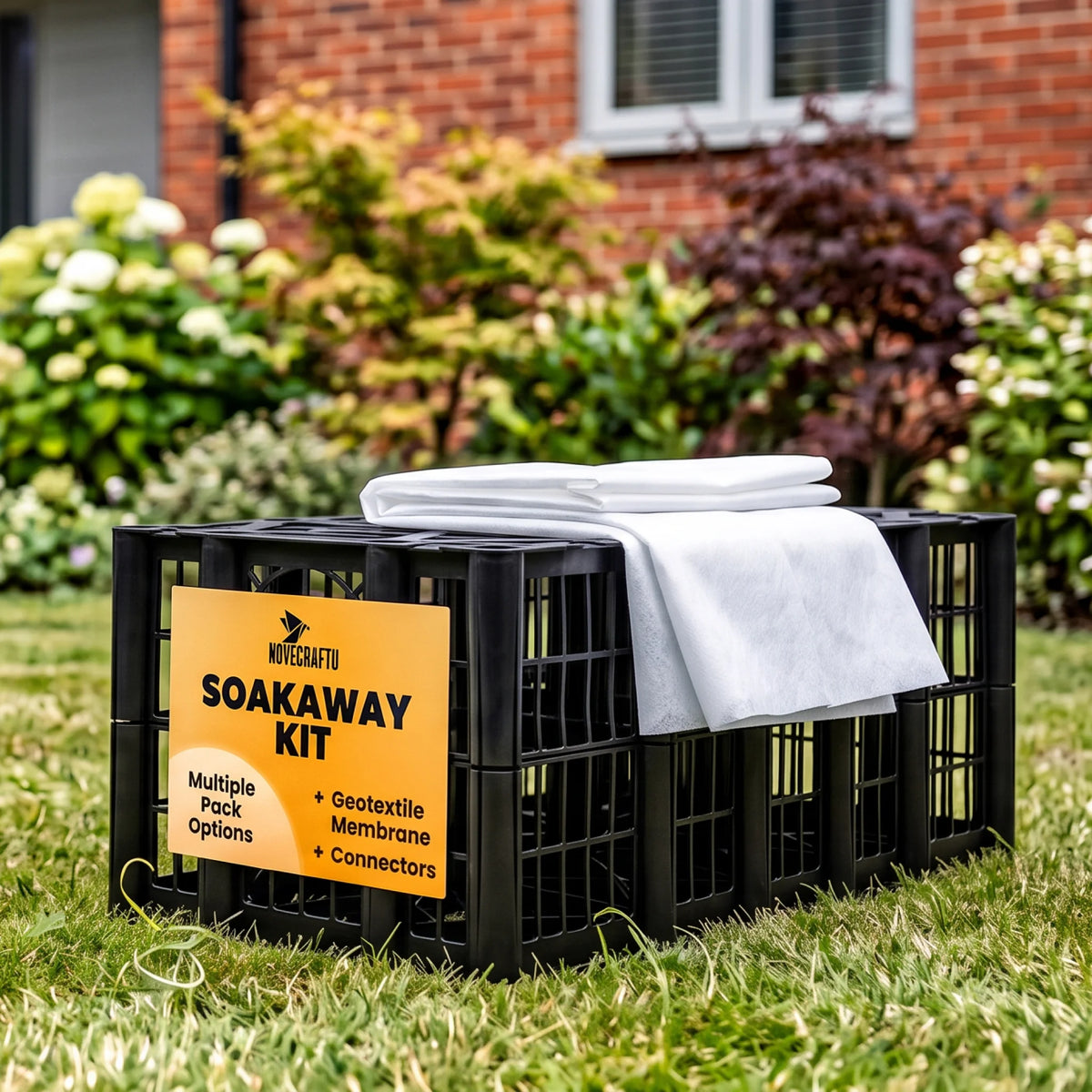 Soakaway crate kit on garden lawn
