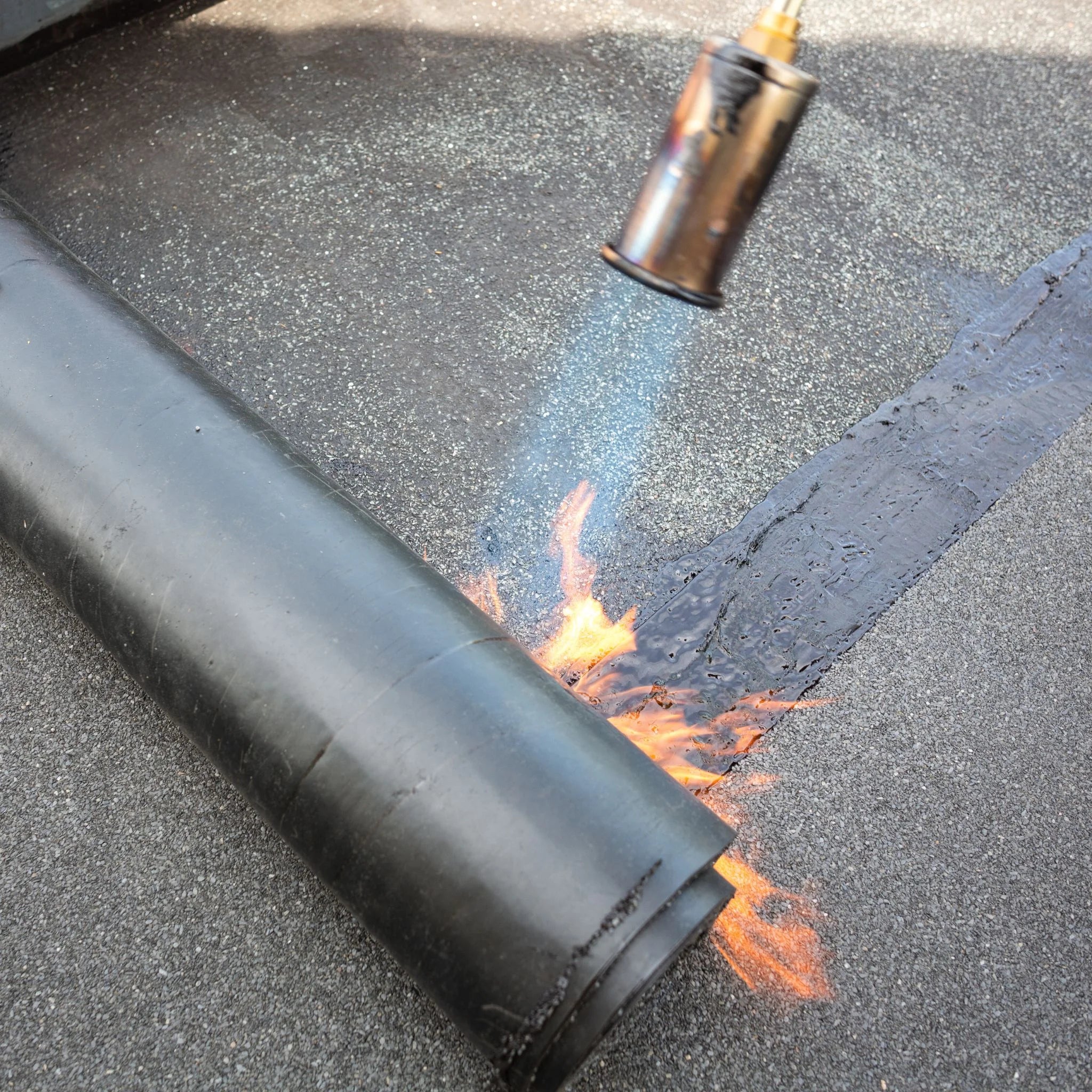 underlay being applied to roof with heat torch