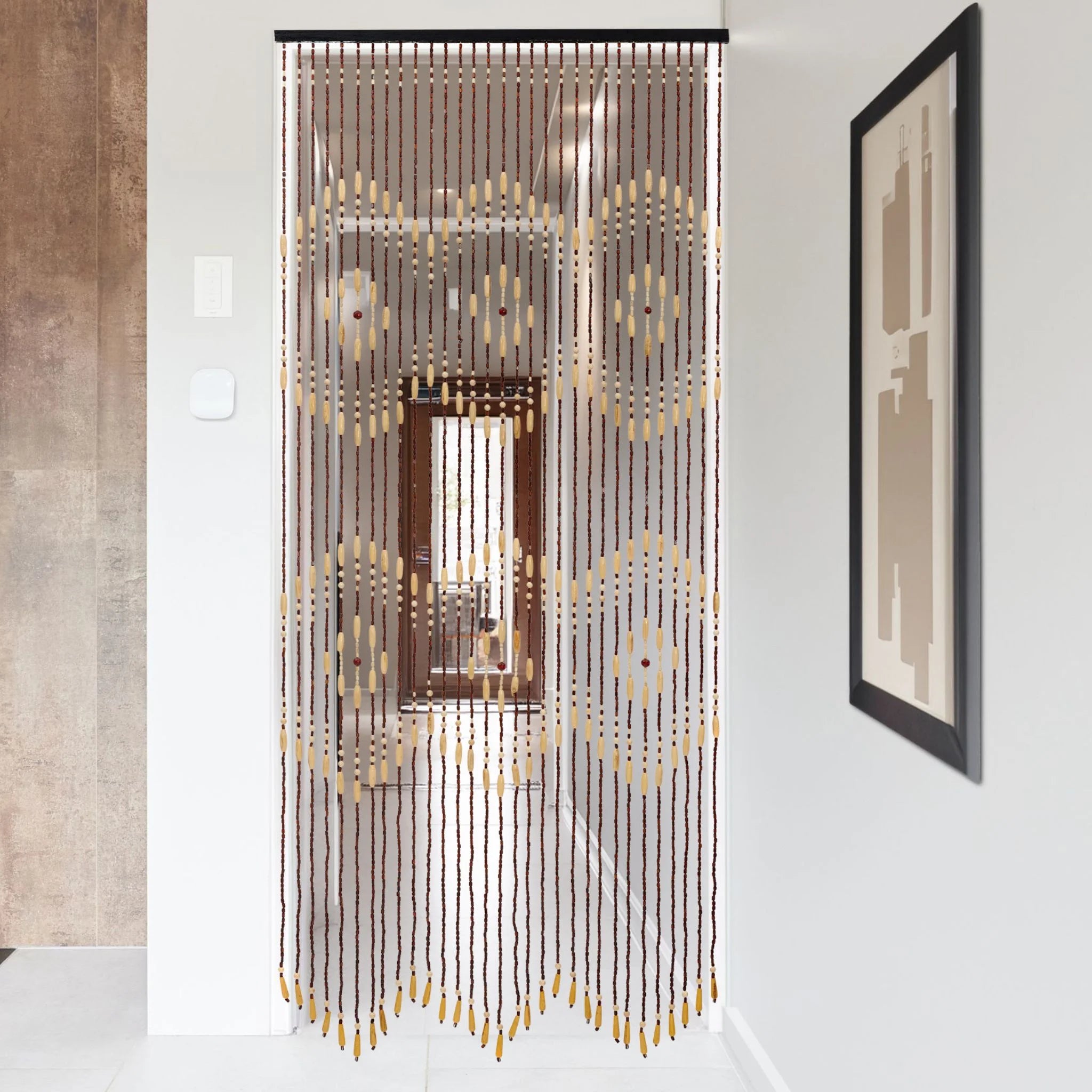 Beaded door curtain in a modern hallway with wall art