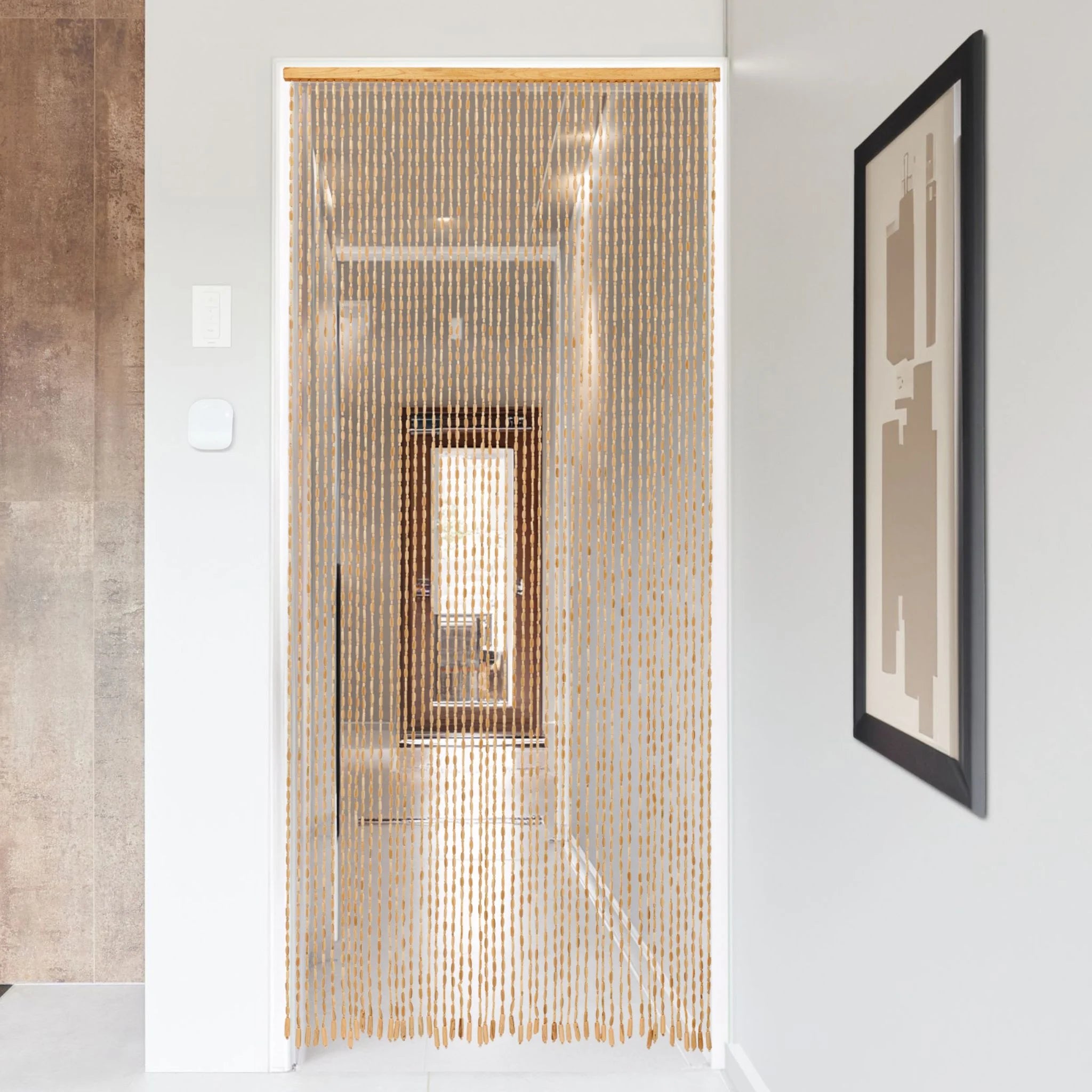 Beaded door curtain in a modern hallway with wall art