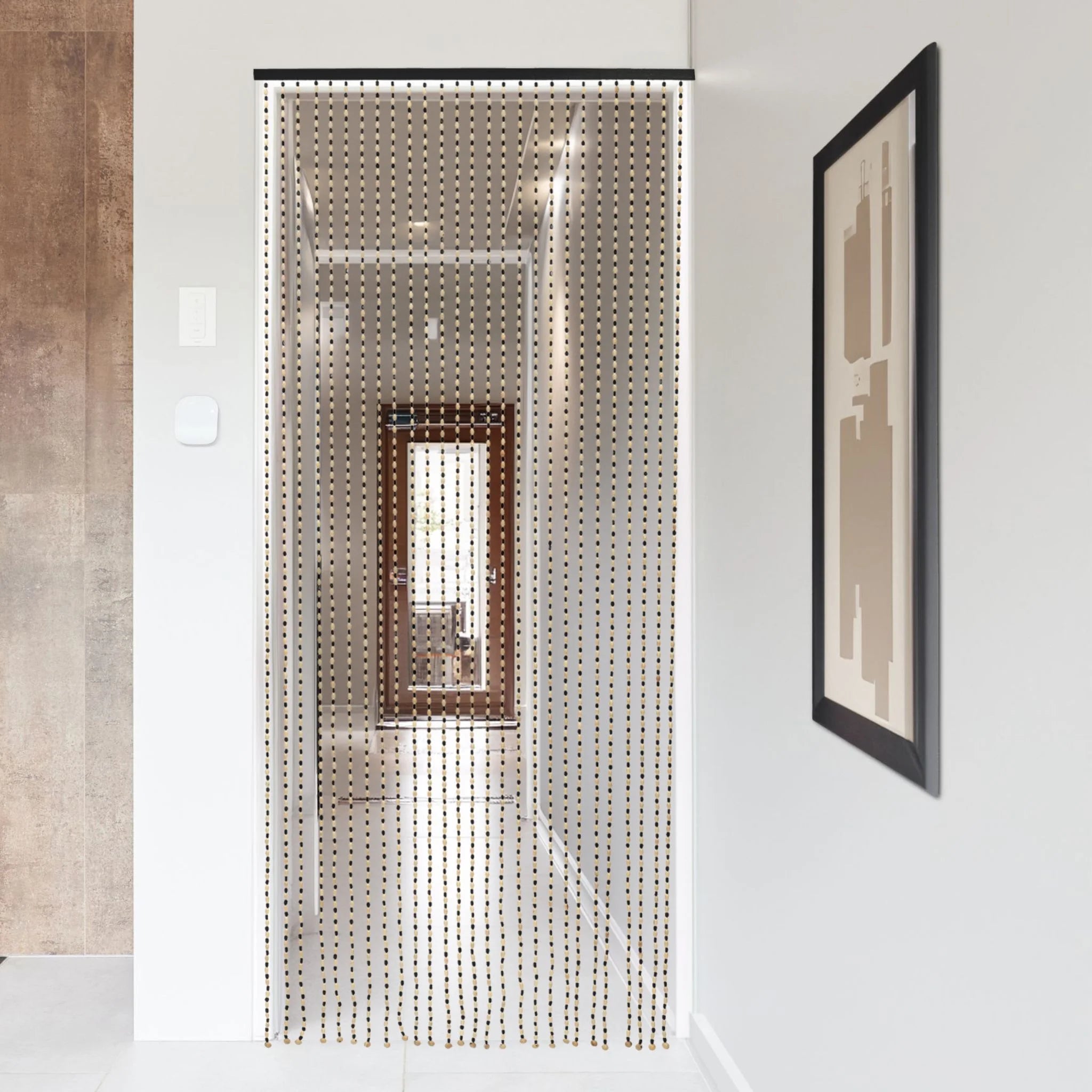 Beaded door curtain in a modern hallway with wall art