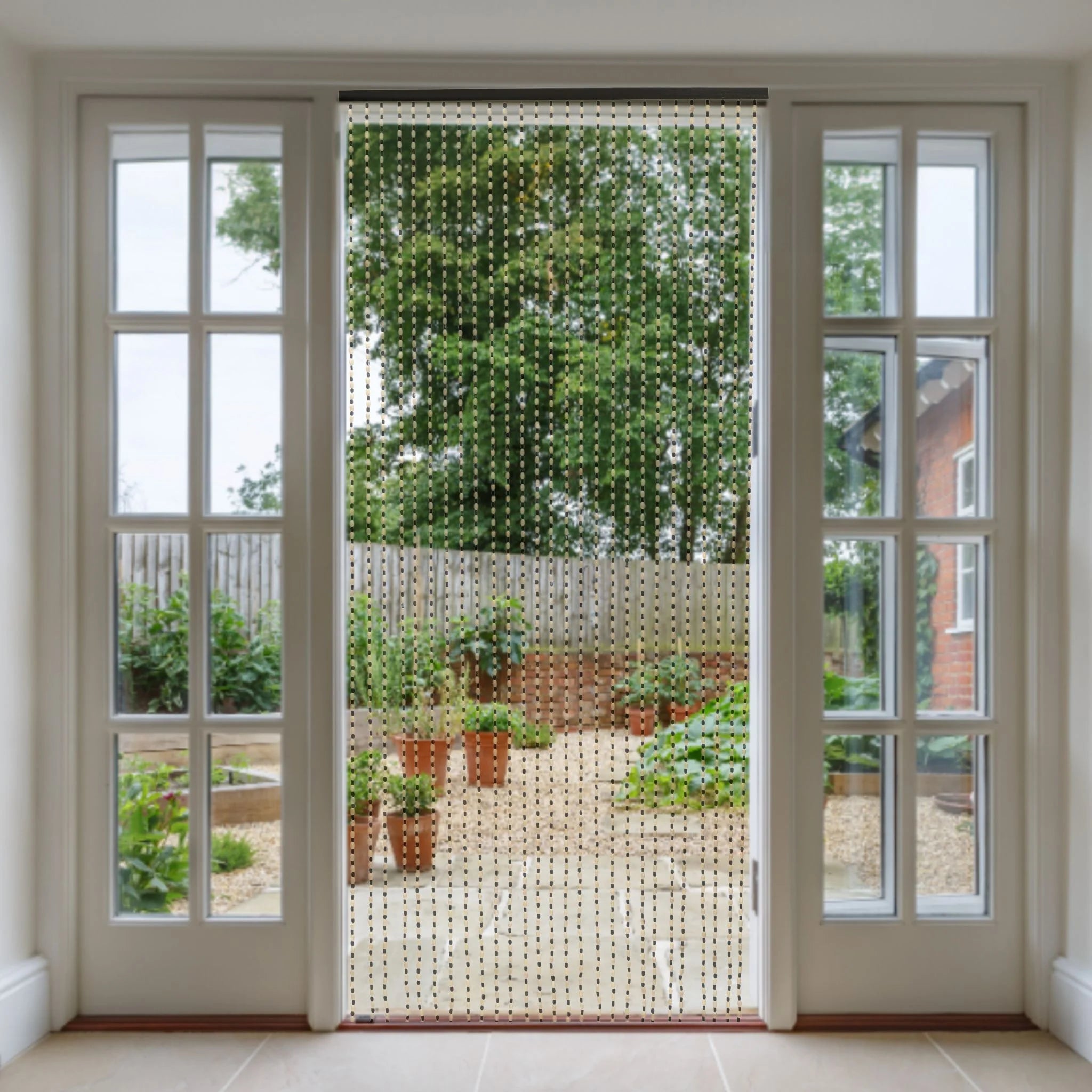 Bead door curtain hanging in doorway to garden